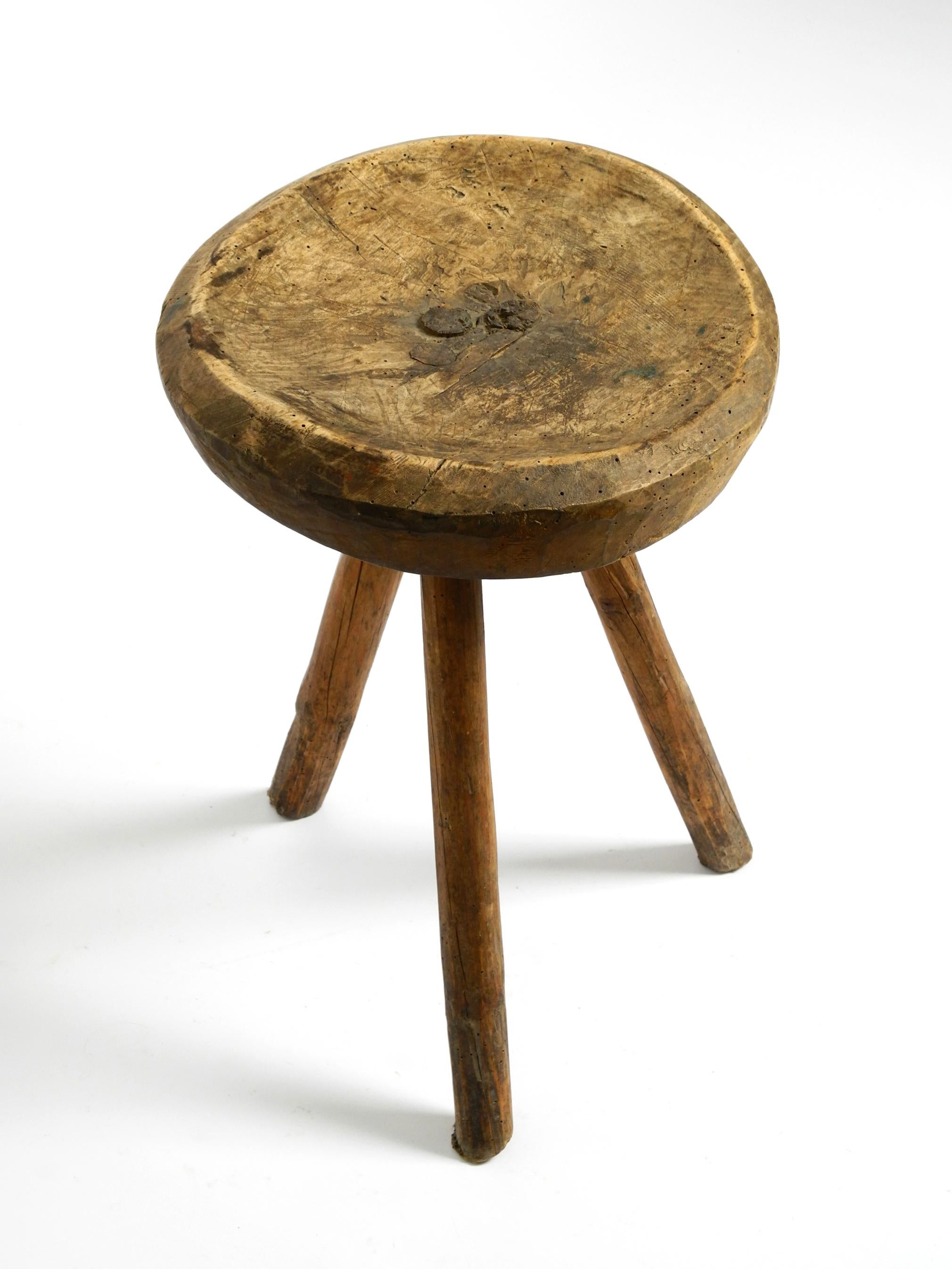 1900s hand-carved three-legged solid wood stool with a fantastic patina For Sale 12