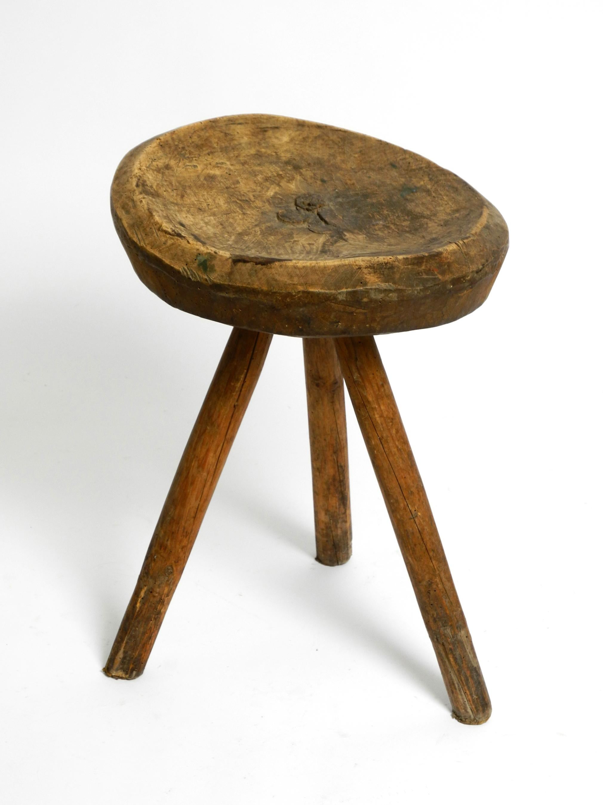 1900s hand-carved three-legged solid wood stool with a fantastic patina In Good Condition For Sale In München, DE