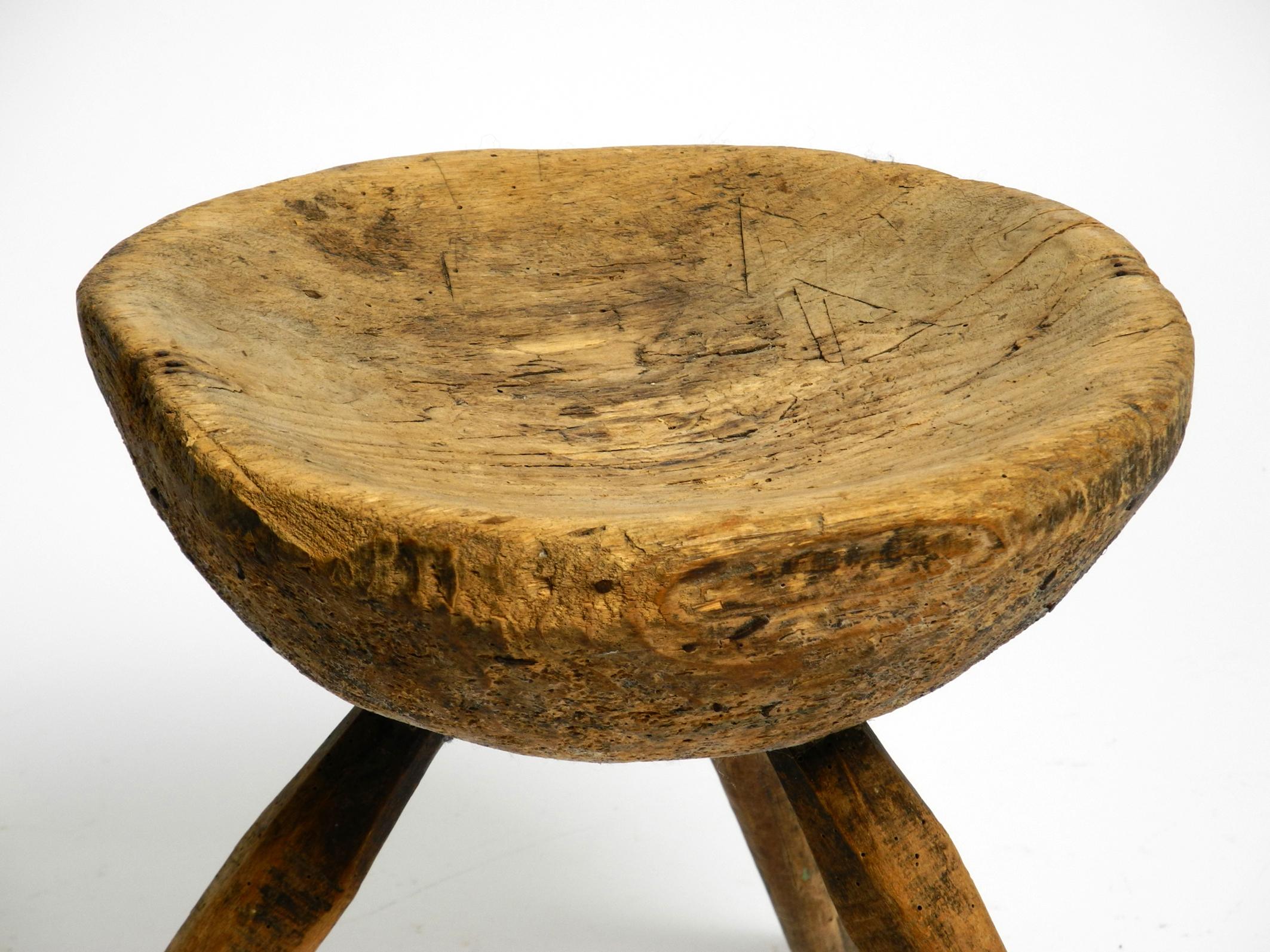 1900s hand-carved three-legged solid wood stool with a fantastic patina For Sale 2