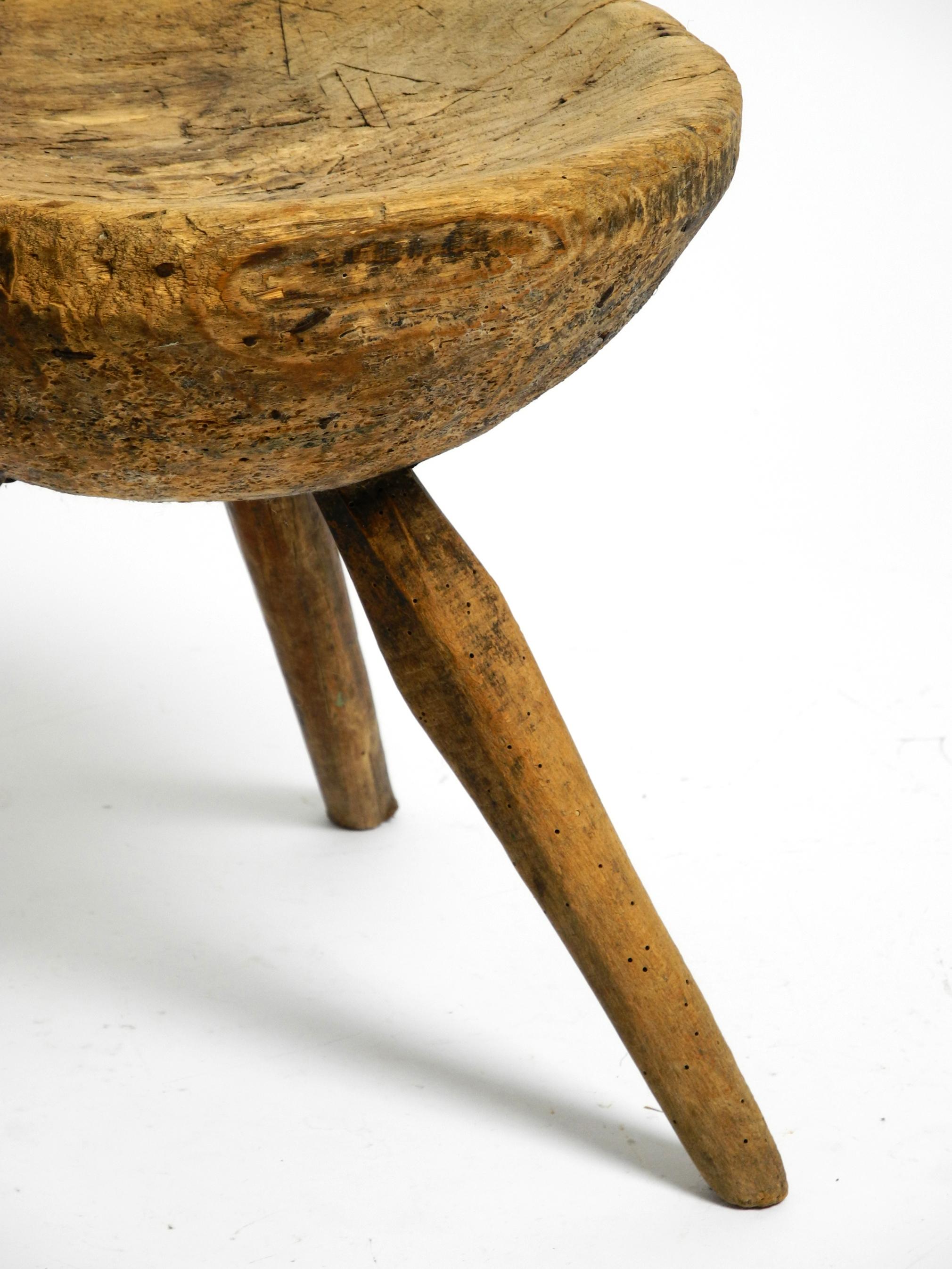 1900s hand-carved three-legged solid wood stool with a fantastic patina For Sale 3