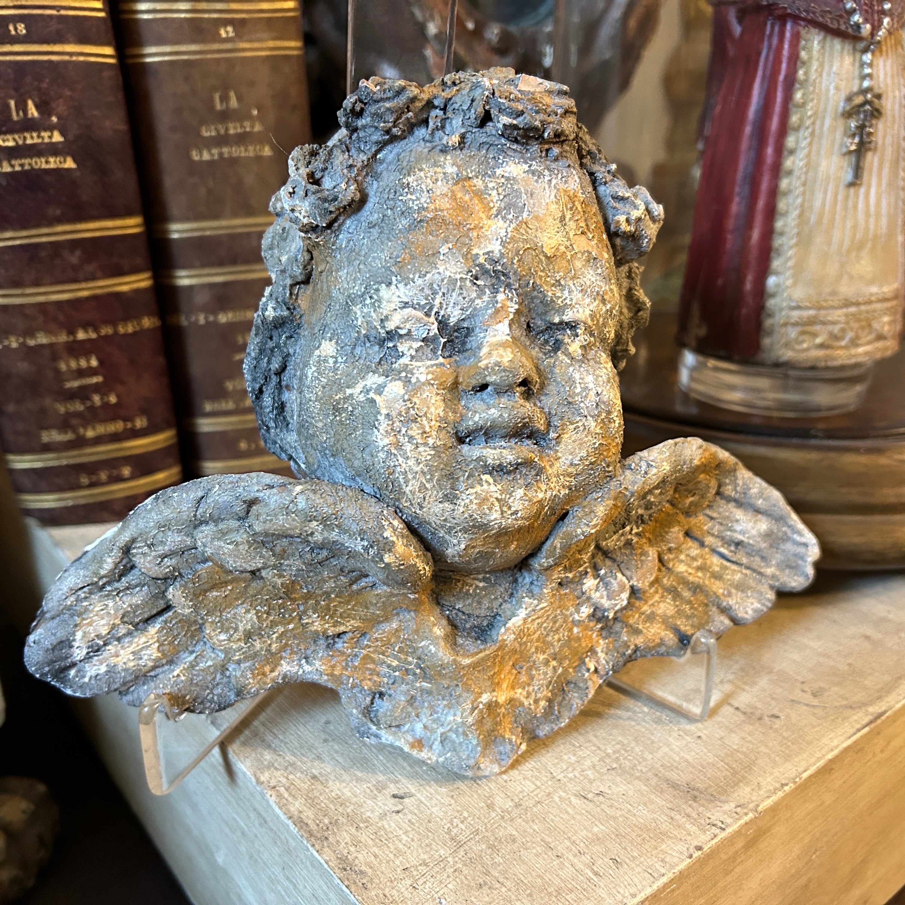 A 1900s hand-crafted terracotta Sicilian angel it' is has been made in the early 20th century on the island of Sicily, It's in original condition and patina, it has been crafted from terracotta, a type of clay that is fired at high temperatures to