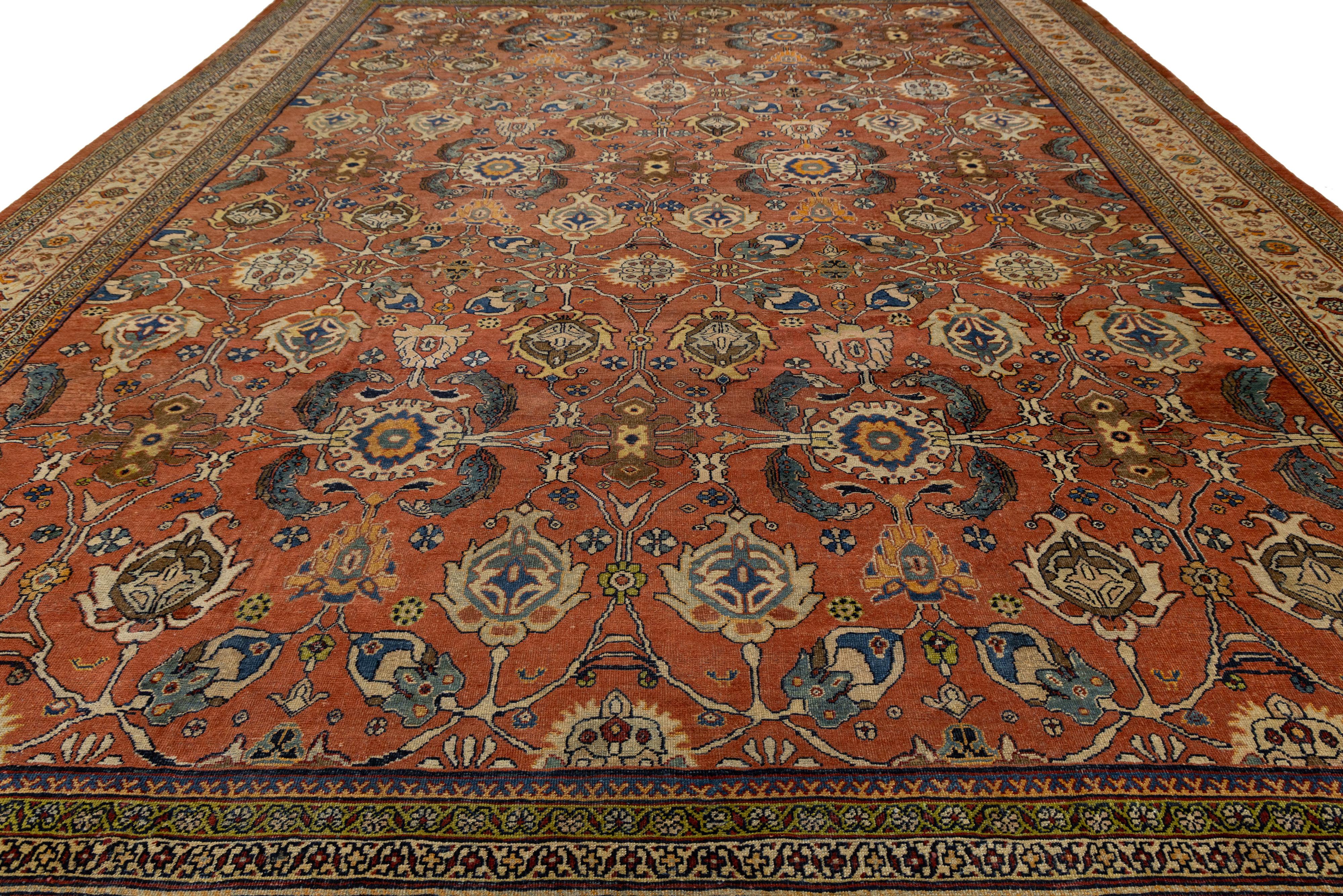 Exceptional antique Persian Mahal rug, hand-knotted in wool with a richly detailed floral and geometric medallion pattern. Features a warm reddish-brown field with intricate motifs in blue, cream, yellow, and green, framed by a multi-band border.