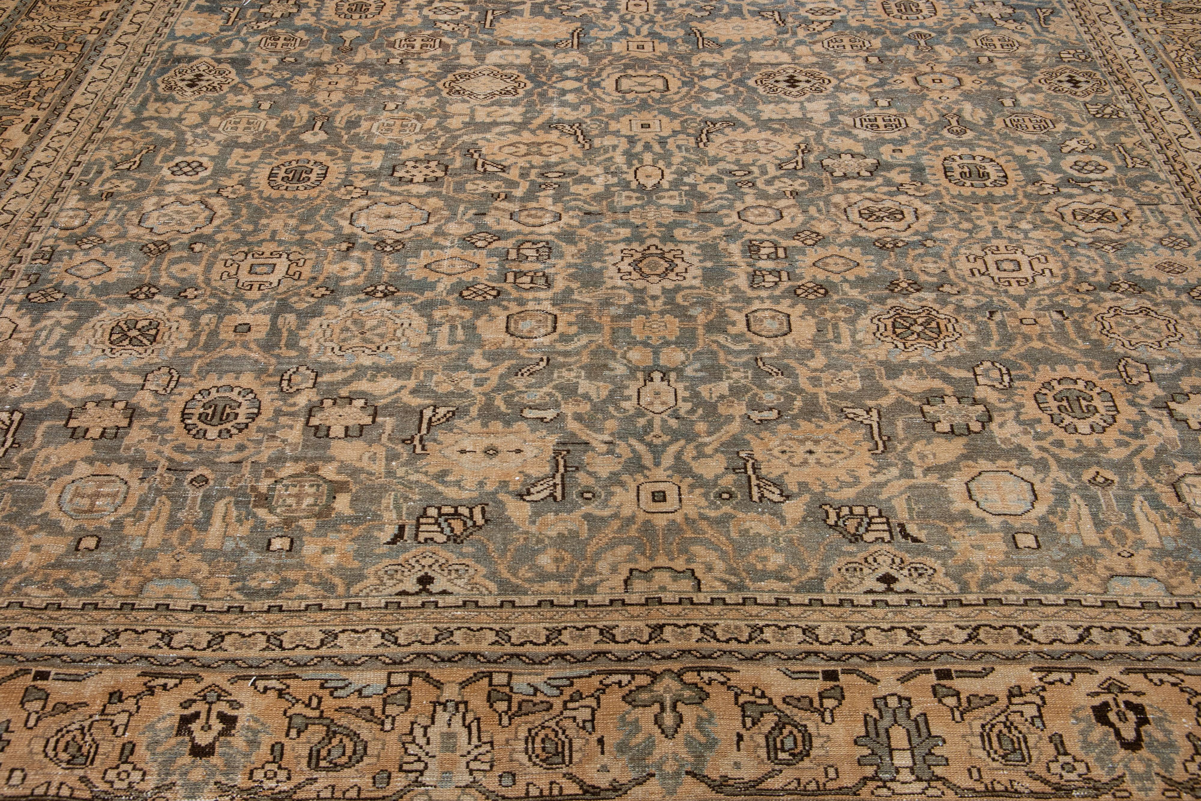 Add some antique flair to your decor with this handmade Persian Malayer wool area rug. It's the perfect accent piece, boasting a rich gray-blue field and muted tones of an allover floral motif.
 
This rug measures: 11' x 17'1