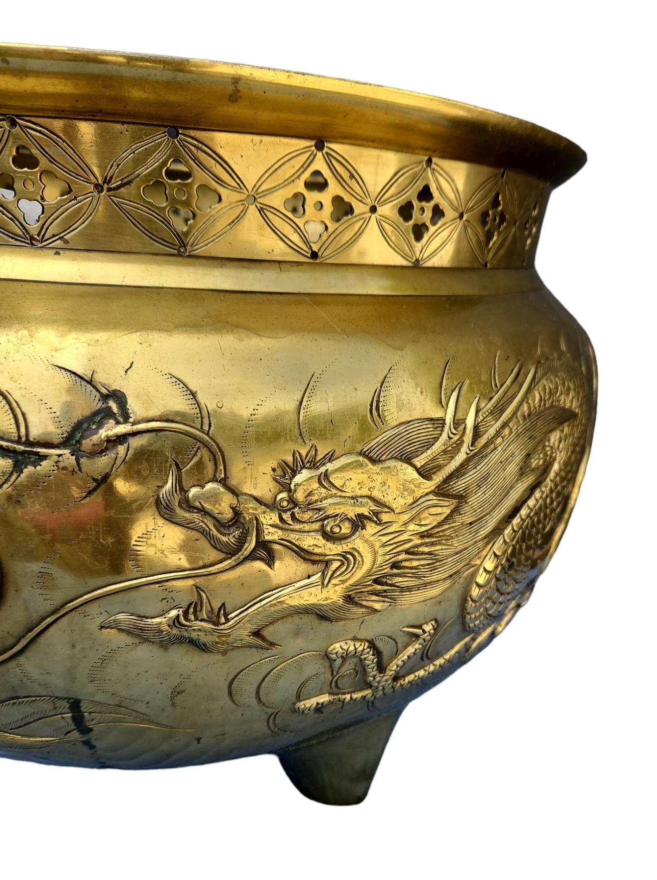 1900s brass (possibly bronze) jardineres with finely detailed dragon motif and pierced rim detail.