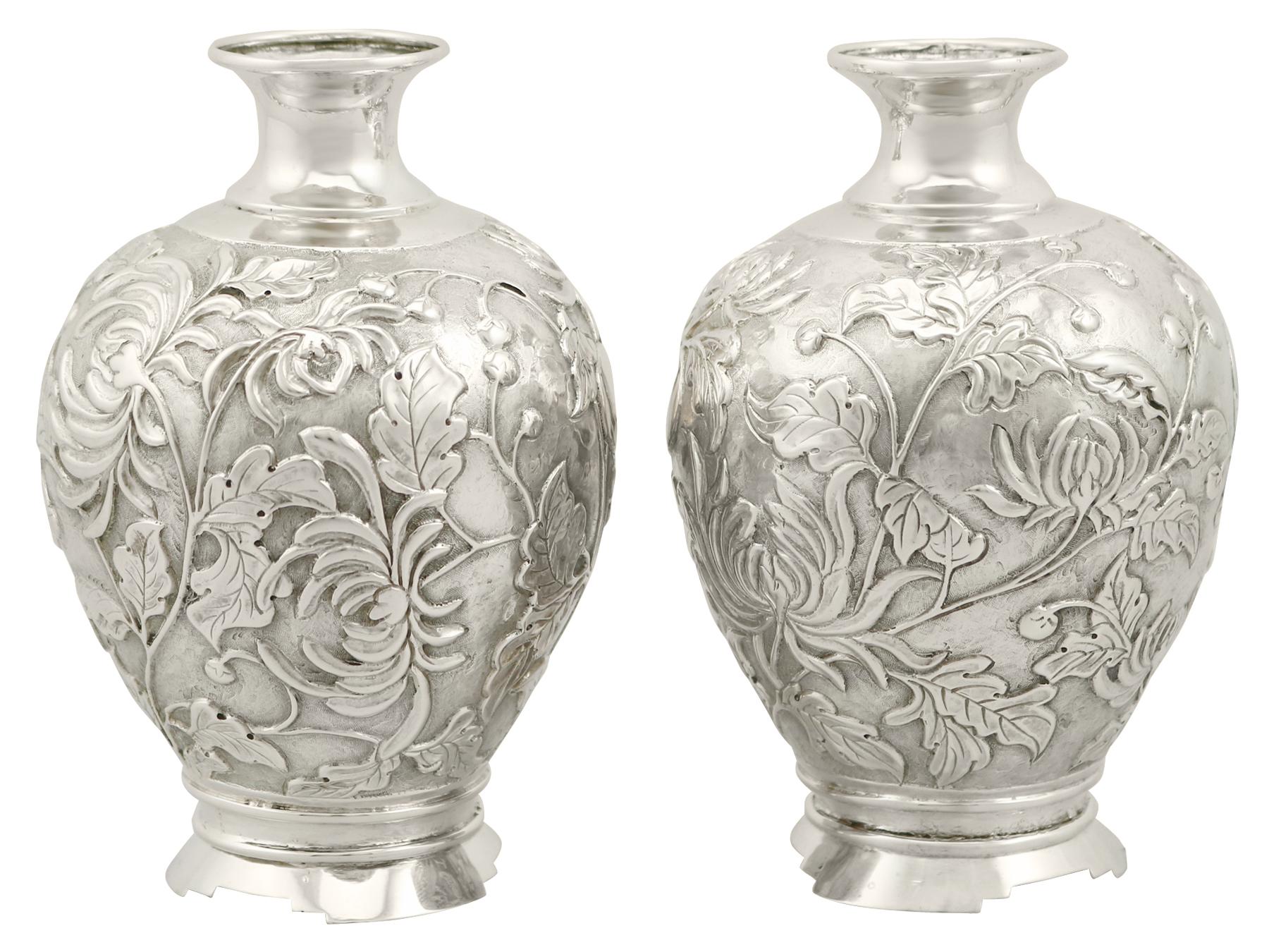 An exceptional, fine and impressive pair of antique Japanese silver bud vases; an addition to our antique Asian silverware collection.

These exceptional antique Japanese silver vases have a circular rounded form with a waisted neck.

The body