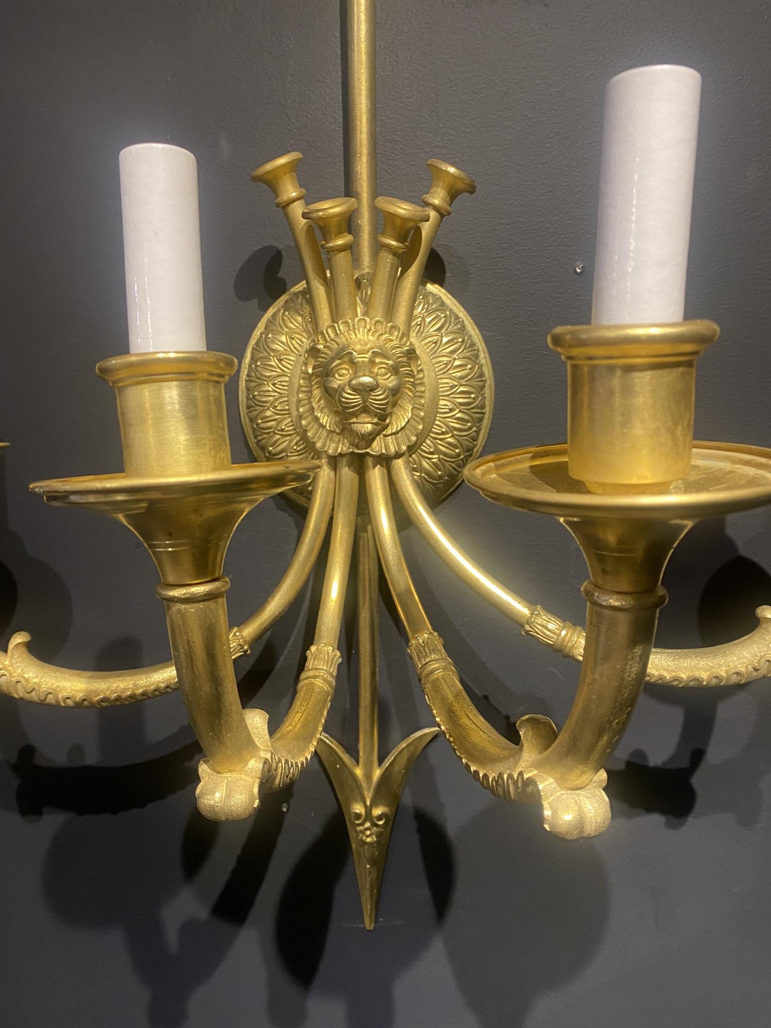 A pair of large unusual size Empire Caldwell sconces with lions head and four lights