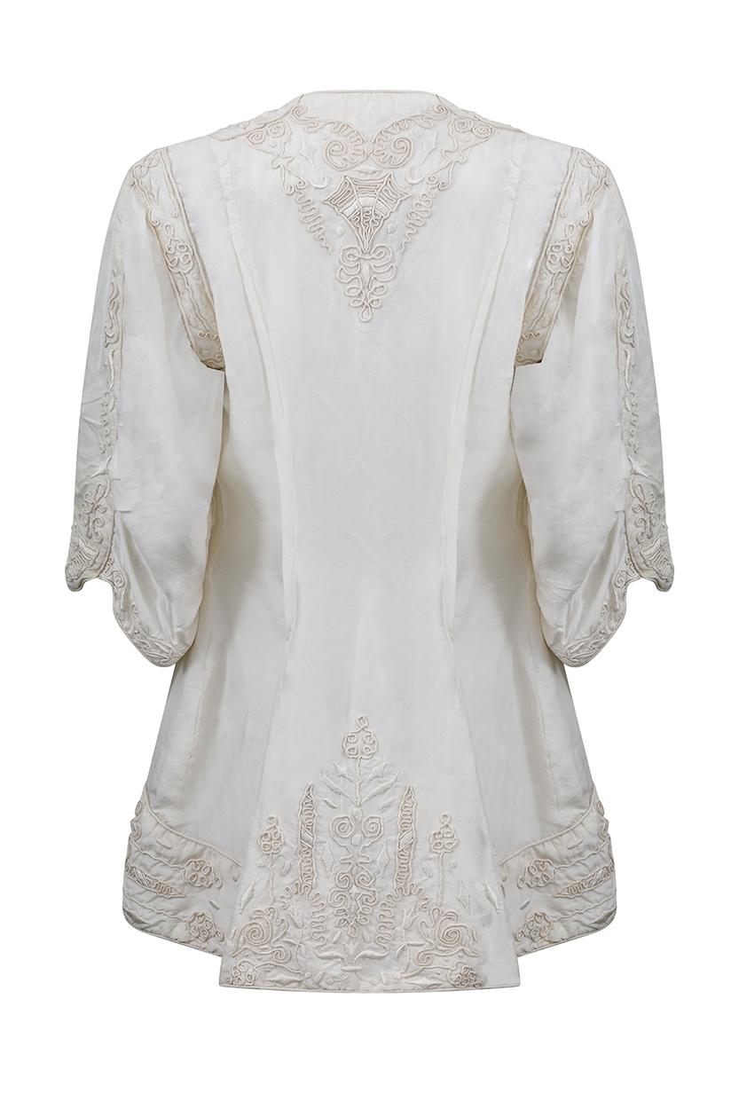 This incredible 1900s or late Edwardian ivory silk jacket is a rare find in absolutely remarkable vintage condition and features some exquisite embellishments. The intricate soutache embroidery incorporates both stitching and chorded designs