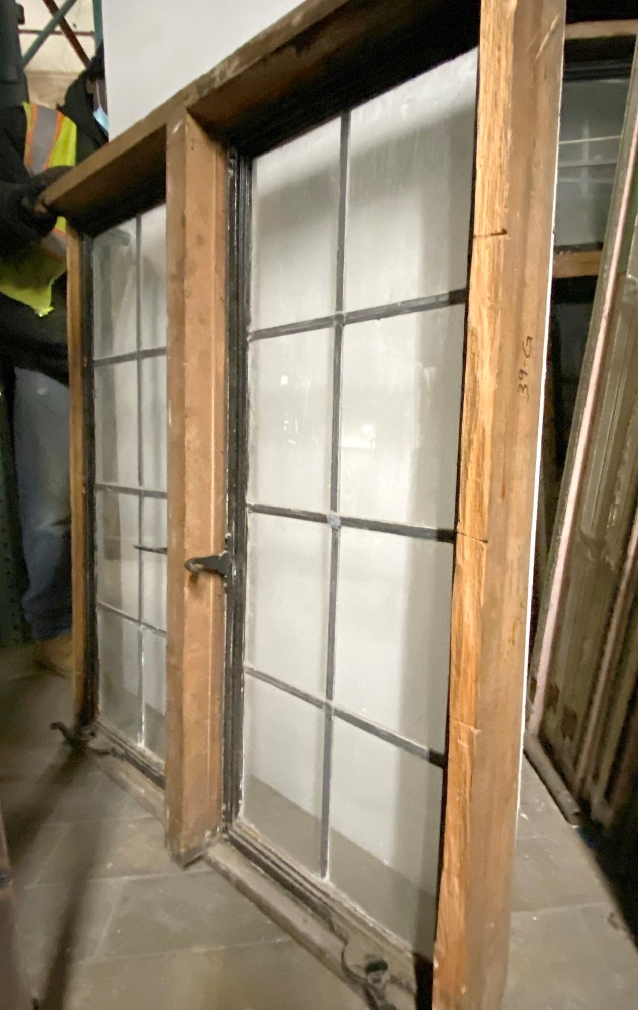 These encasement windows are from a Tudor estate originating from the early 1900's. They have an industrial steel frame with 8 panes of leaded glass on each side with all hardware intact as pictured. The hardware includes original bronze hand cranks