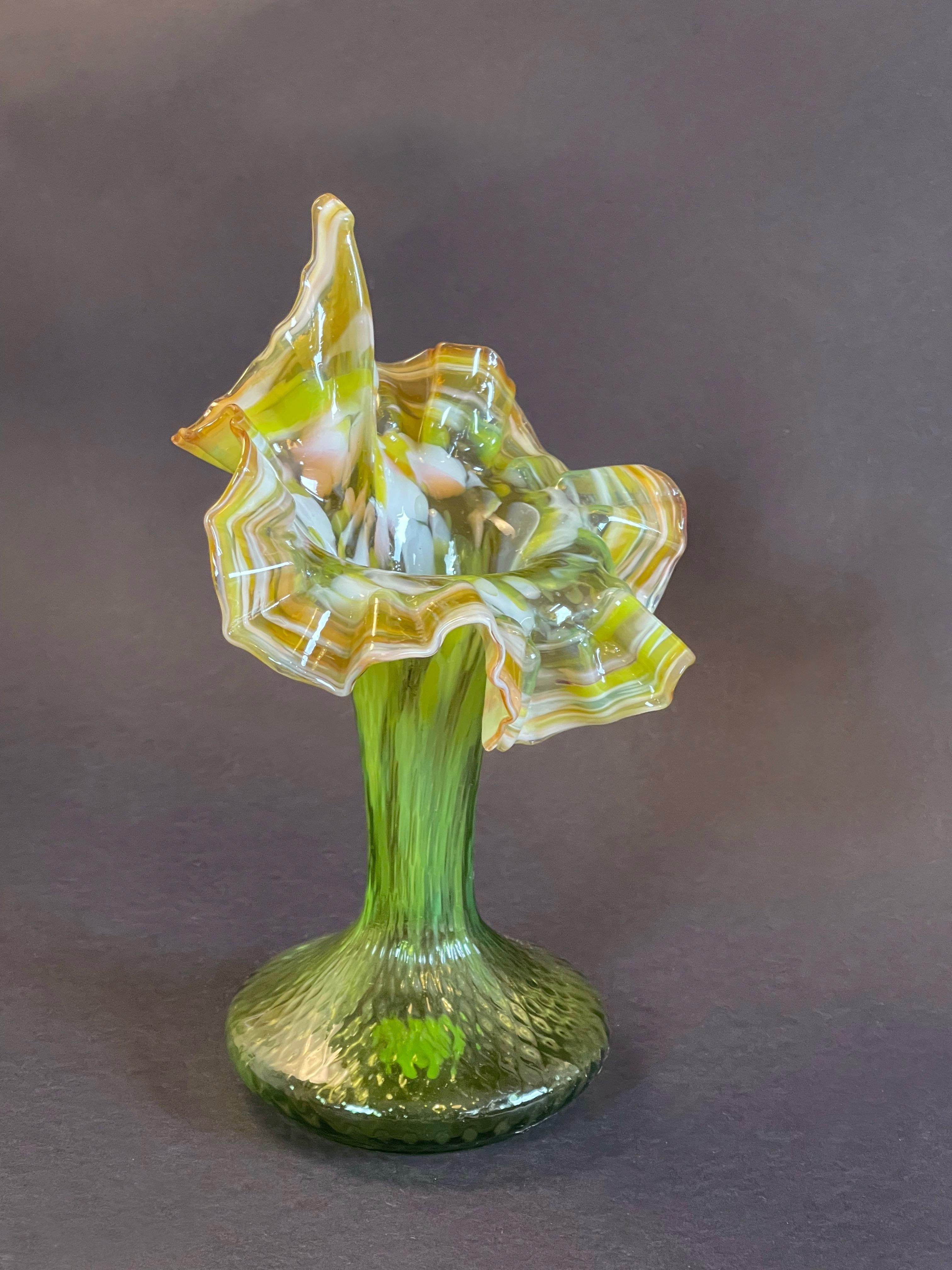 Rare art nouveau vase in a beautifully hand crafted glass, with an almost exploding Sumptuous flower,
once holding flowers it will be a true cornucopia.
Here held in a juicy green popping up like a French Tutu ready to dance!
Likely made in France.