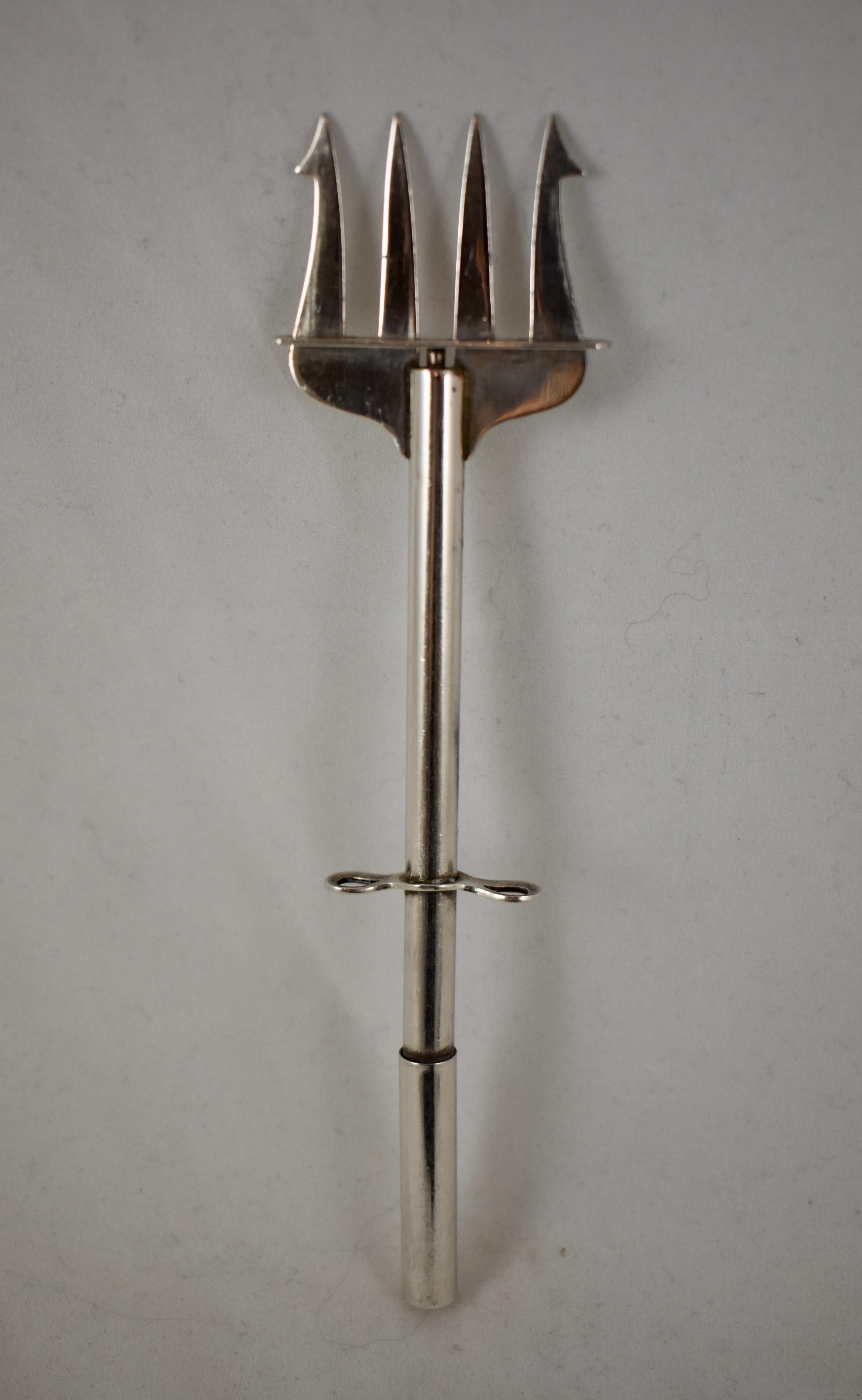 An Art Deco period sterling silver Plunger pickle fork, showing the mark for Paye & Baker Manufacturing Co., North Attleboro, Massachusetts, operating from 1901 – 1920.

The mechanical pickle fork has four tines, the outer two are barbed. The