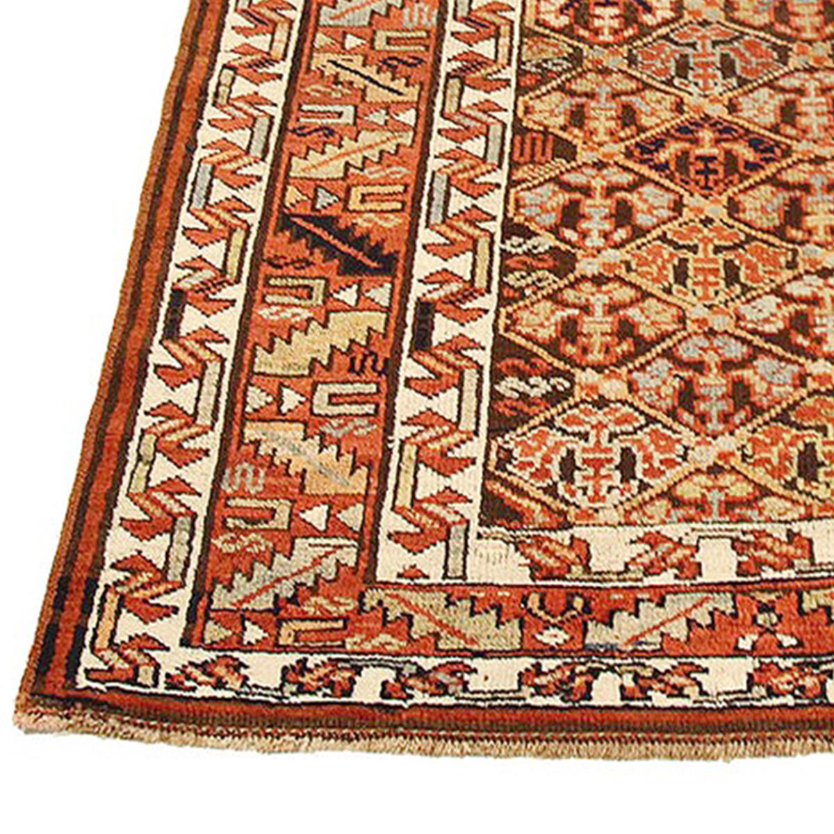 Antique Persian runner rug handwoven from the finest sheep’s wool and colored with all-natural vegetable dyes that are safe for humans and pets. It’s a traditional Bijar design featuring floral details in brown and red over an ivory field. It’s a