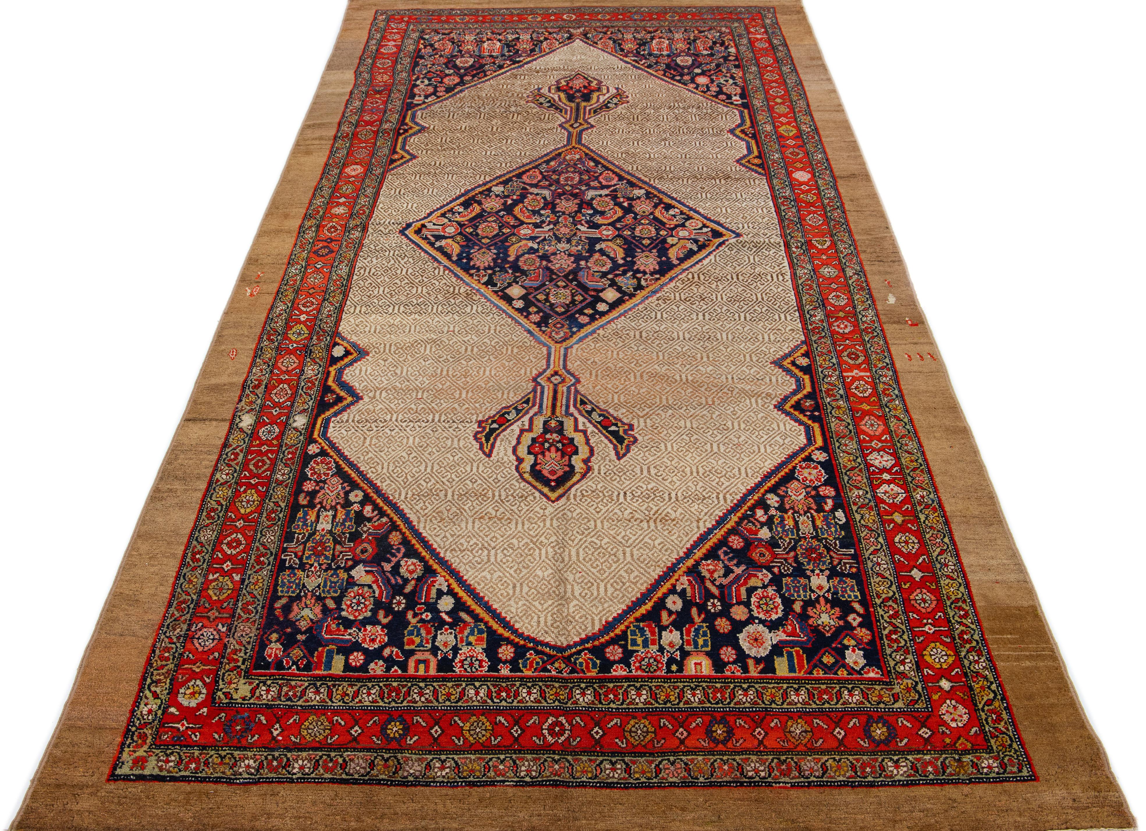 Beautiful antique Persian hand knotted wool rug with a beige color field. This piece has multicolor accents in a gorgeous blue medallion design.

This rug measures 6'6' x 13'9