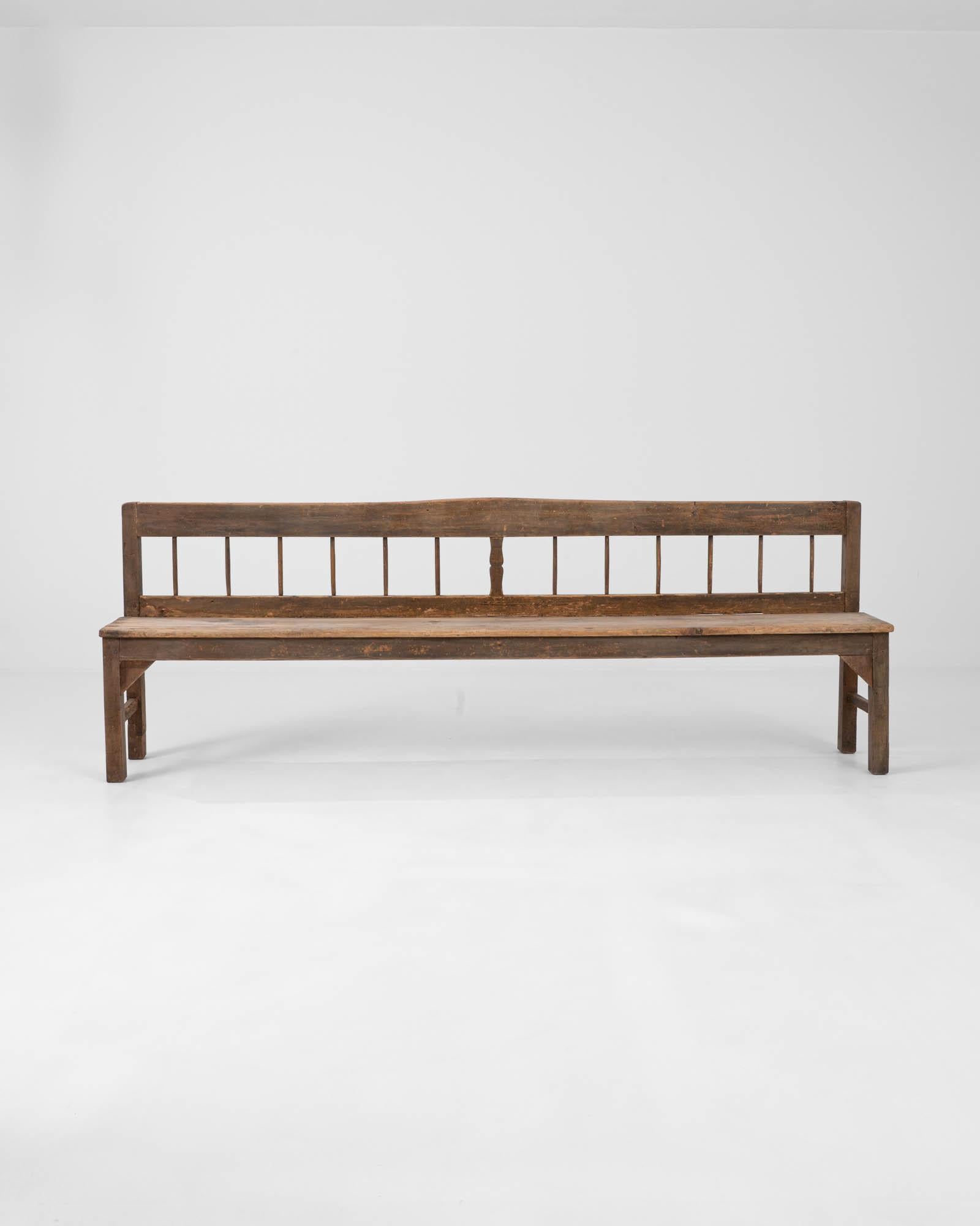 Behold the 1900s Scandinavian Wooden Bench, a piece that embodies the essence of Nordic simplicity and the enduring strength of heritage craftsmanship. This long, solid bench, with its straight lines and unpretentious design, tells a story of many