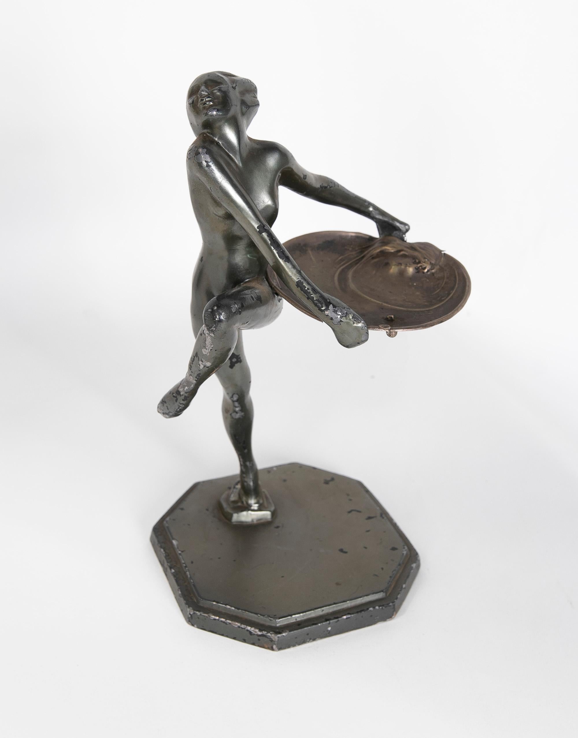 1900s Signed Art Deco metal sculpture of a woman with a silver tray.