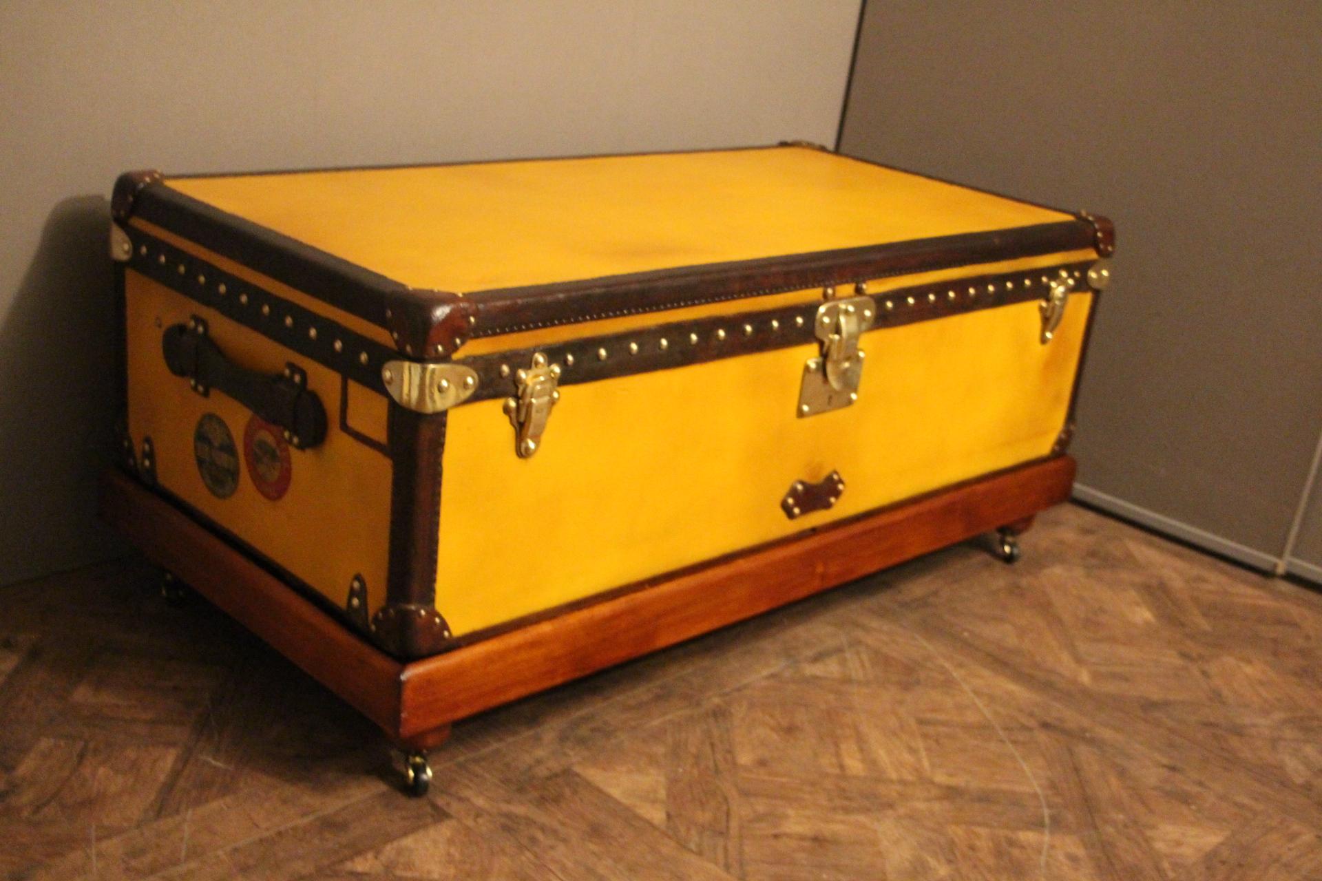 Very nice yellow canvas Louis Vuitton steamer trunk, featuring Louis Vuitton stamped solid brass lock, clasps as well as all its studs. Beautiful and rich color between orange and yellow, leather trim and side handles. Unusual and elegant color.
It