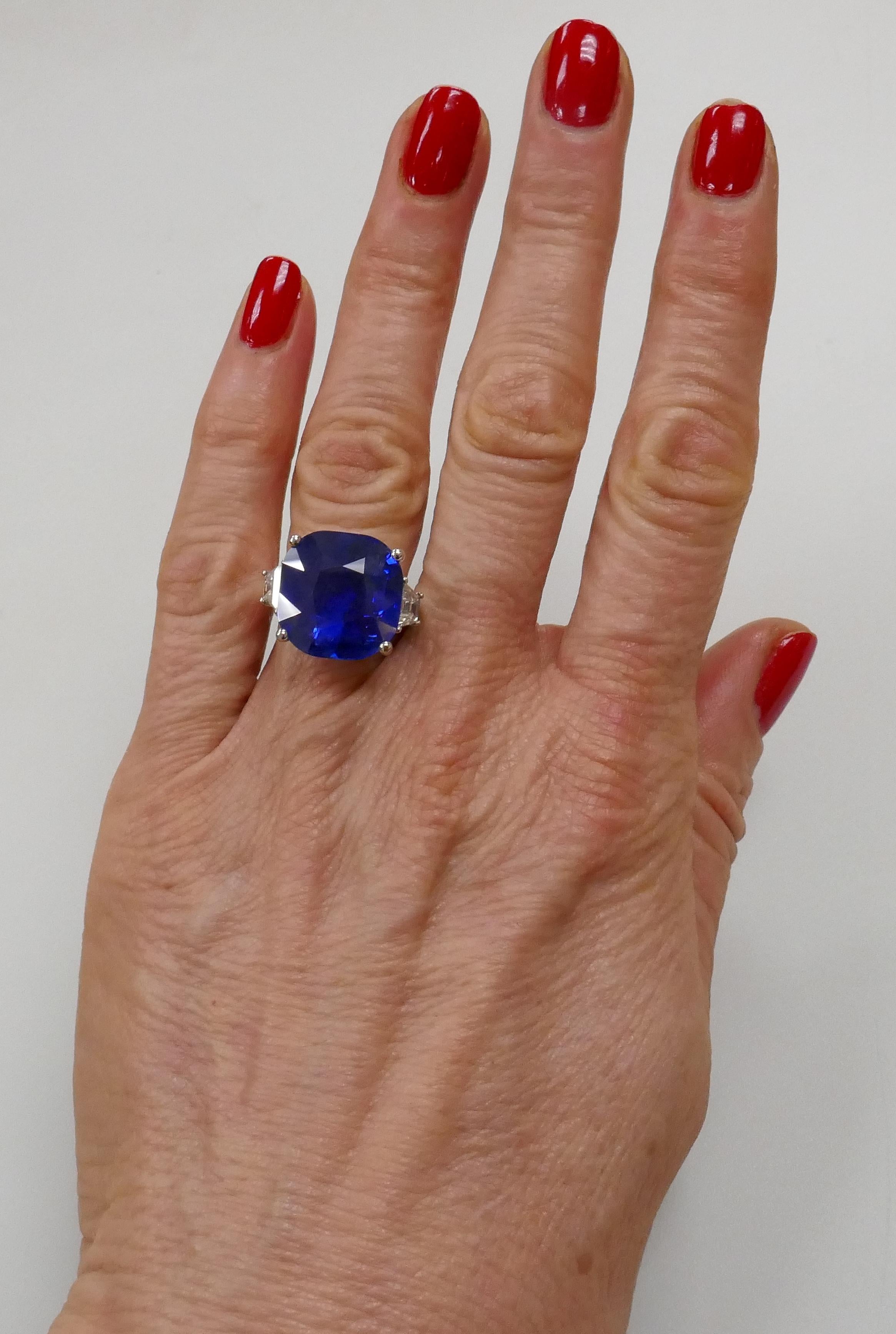 Stunning 19.02 carat natural Ceylon cushion cut sapphire ring flanked with two trapeze diamonds set in 18k white gold. The sapphire comes with a Swiss Gemological Institute gemstone report stating that there are no indication of heating (see picture