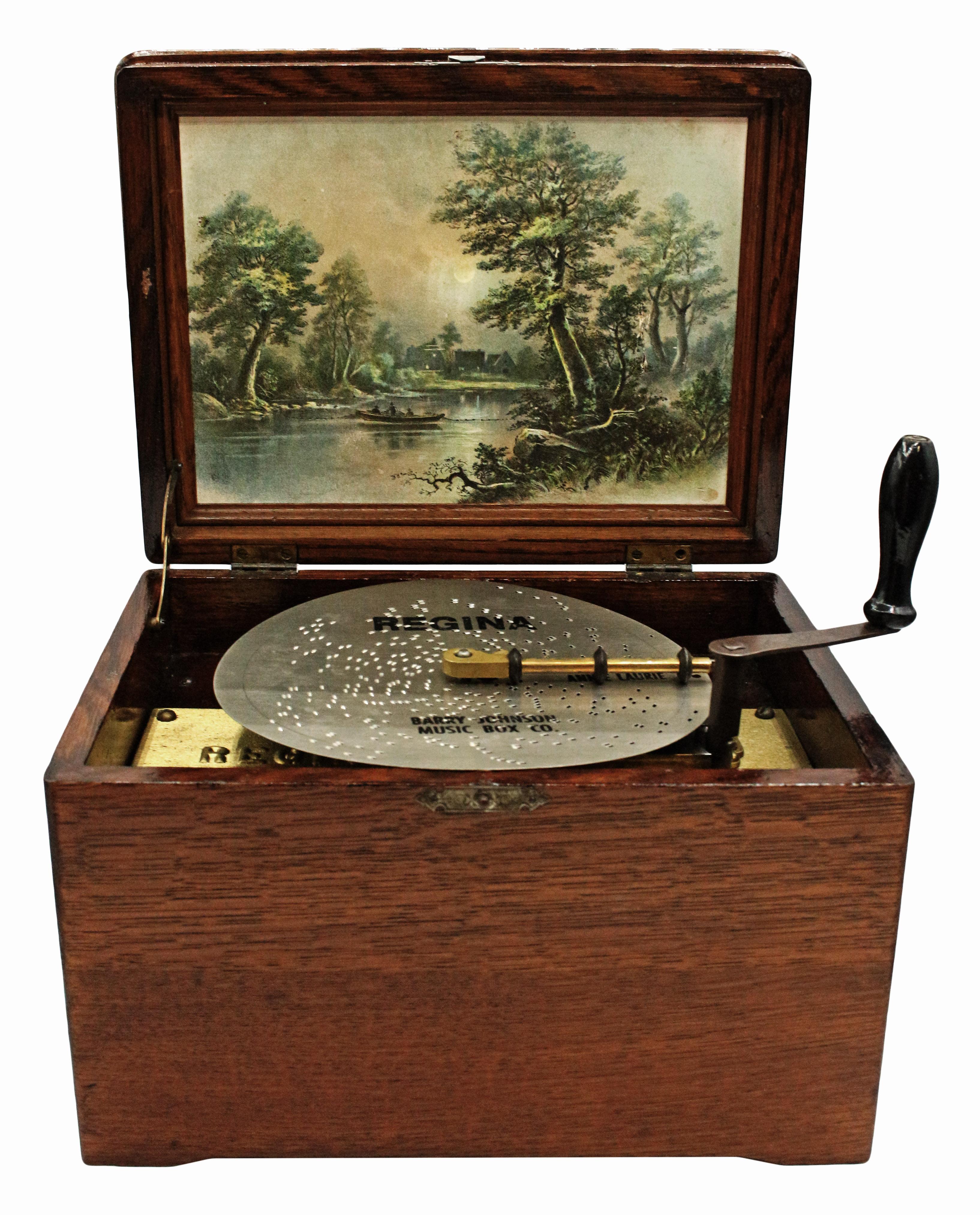 1902 Regina music box with 3 discs and crank. Molded oak case. One additional disc should not be used. 