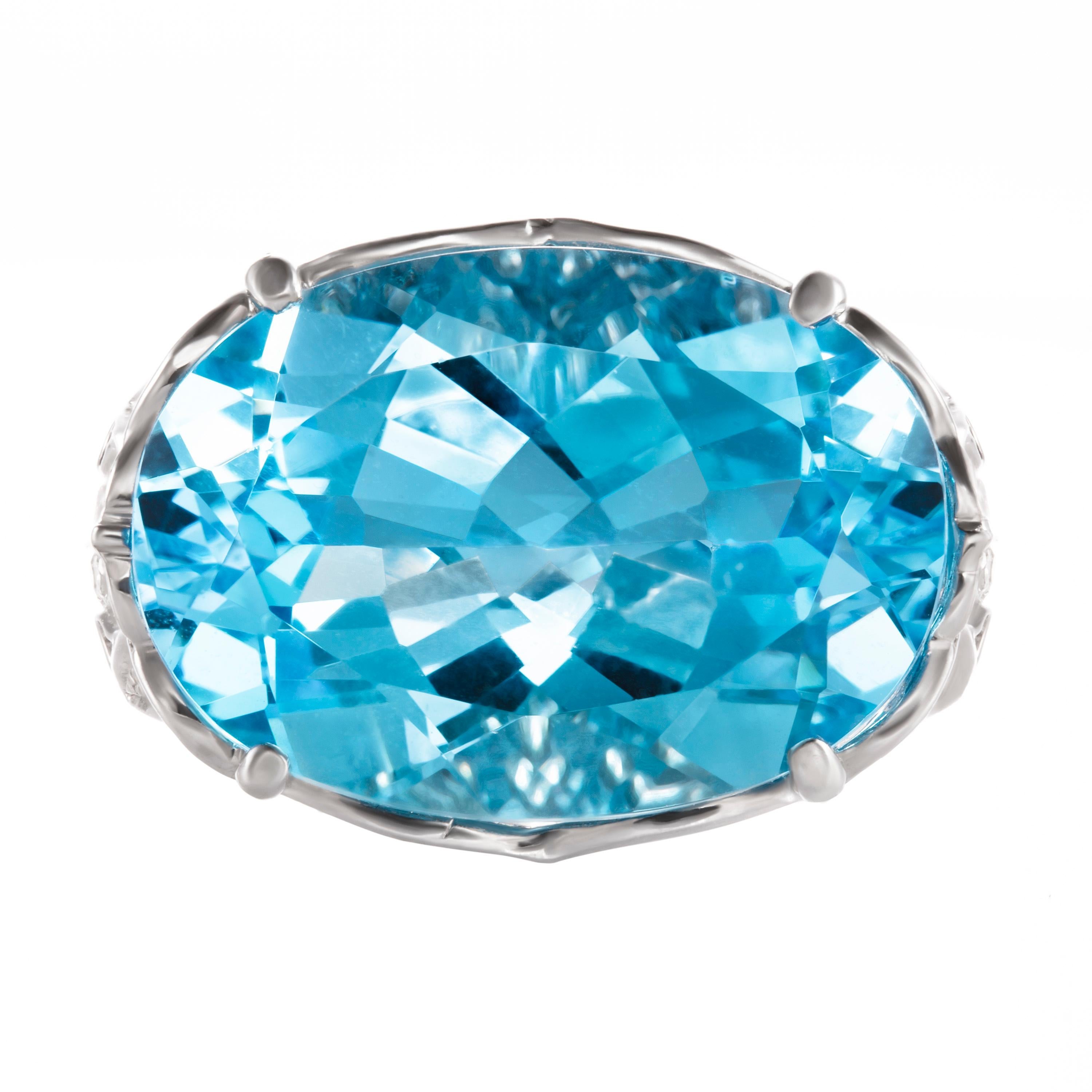 Distinguished by a stunning 19.04 carat oval-cut blue topaz, Butani's ring is destined to make a statement. It's set atop an 18-karat white gold band that's encrusted with 2.45 carats of light-catching white diamonds. Currently a ring size US 6.5. 