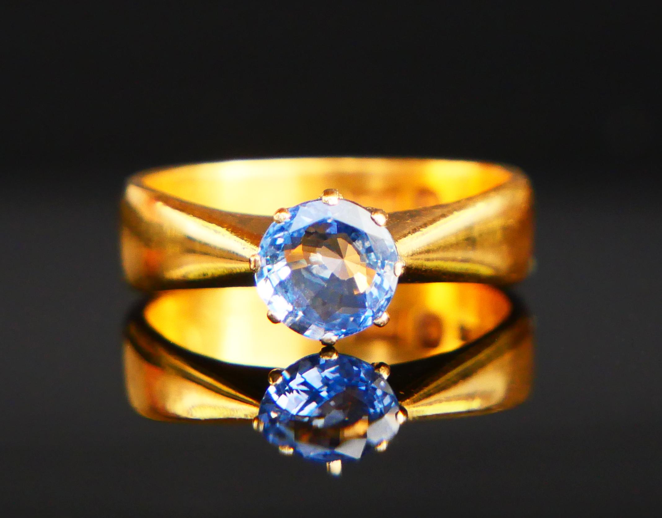 Elegant 120 Years old 23K Gold and Blue Ceylon Sapphire Ring.

Wide Band 5 mm at widest in solid 23ct Gold + claw set natural old diamond hand-cut natural Ceylon Sapphire of light Blue or Cornflower color Ø 6.5 mm x 3 mm deep / ca. 1.25 ct.