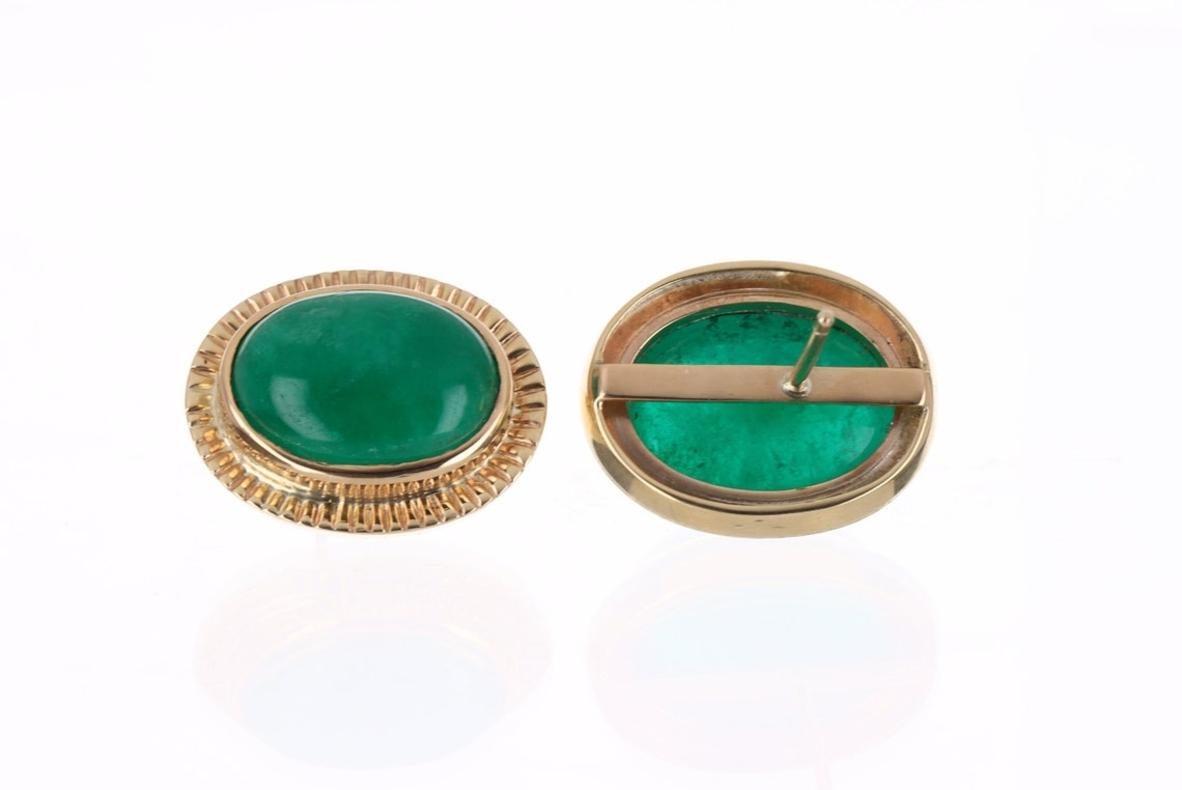 Featured here is a beautiful very rare set of JUMBO large Colombian oval cut cabochon emerald studs dexterously handcrafted in solid fine 14K yellow gold. Displayed are rich deep dark forest green emeralds with very good transparency, accented by a