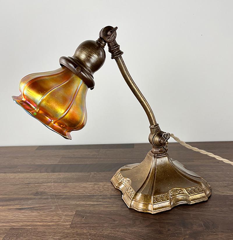 Very elegant early 1900s piano or roll top desk lamp with original restored finish. This lamp is fitted with a beautiful gold aurene squash American art glass shades attributed to Stueben. Fully adjustable at the base and the shade and features a
