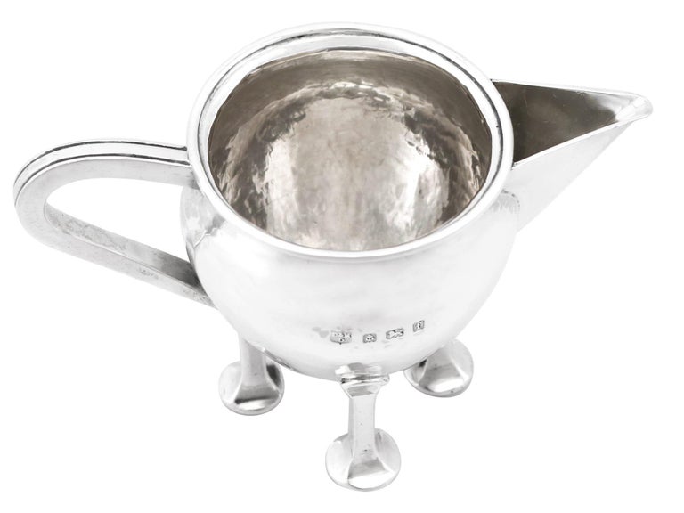 An exceptional, fine and impressive antique Edwardian English sterling silver cream jug in the Arts & Crafts style; an addition to our range of collectable silverware.

This exceptional antique Edwardian silver cream jug, in sterling standard, has