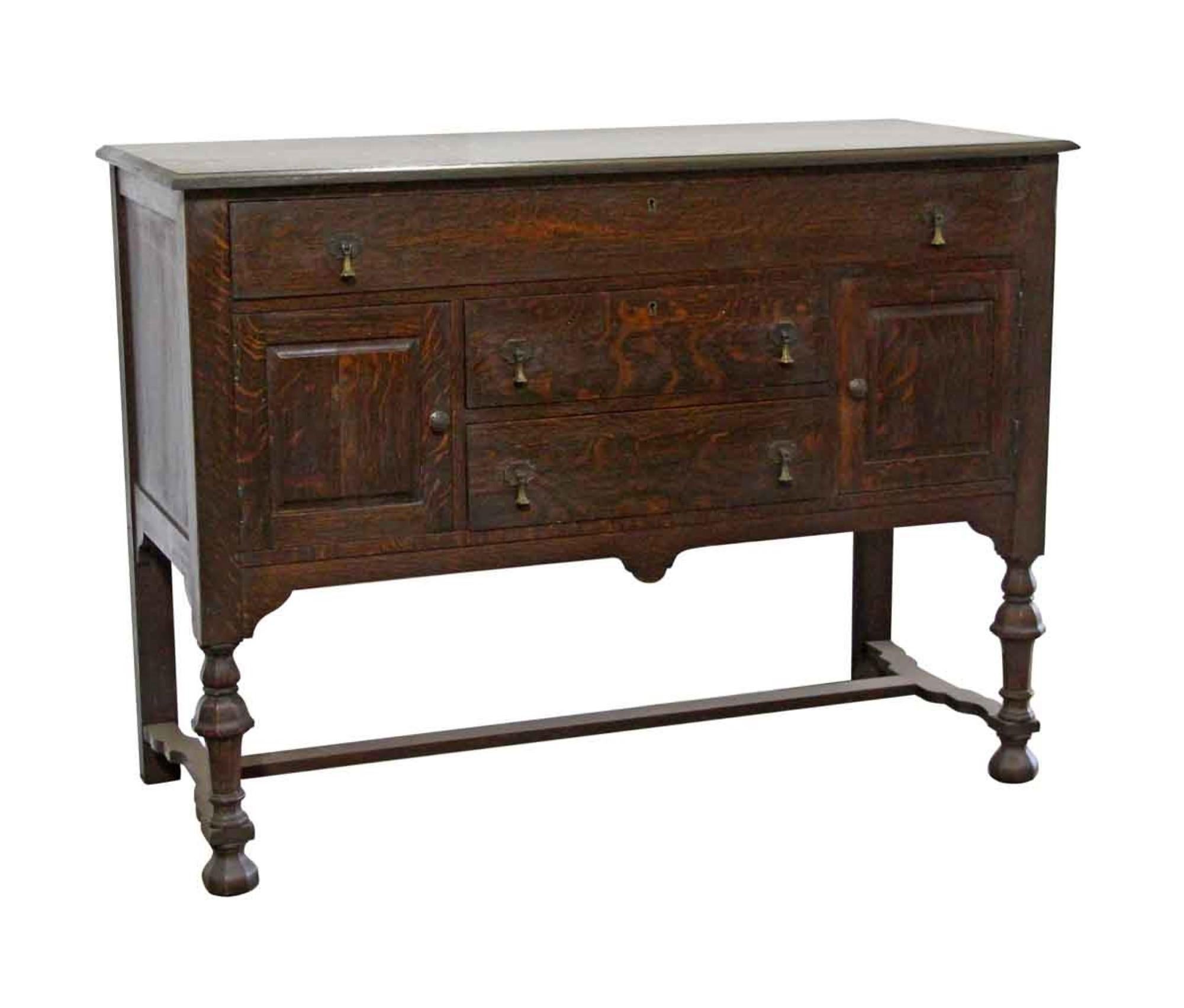 1905 Arts & Crafts style tiger oak sideboard with a dark finish, three drawers and two cubicles. Featuring teardrop drawer pulls. Made by Easton Manufacturing Company, Easton MD. This can be seen at our 400 Gilligan St location in Scranton, PA.