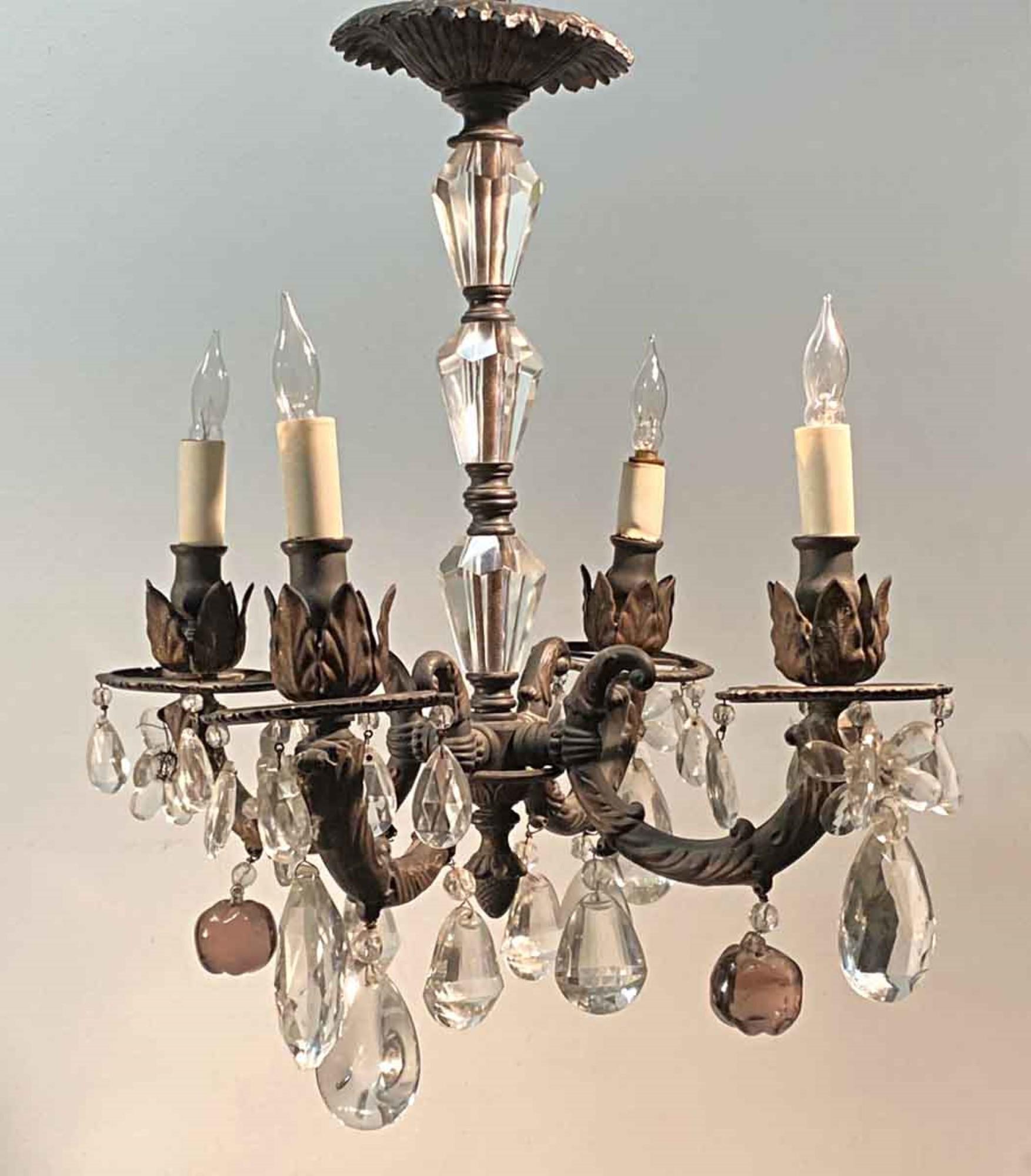 1905 French gas chandelier converted to electric. Four lights. The frame is ornate cast iron fitted out with crystals. This can be seen at our 400 Gilligan St location in Scranton, PA.
