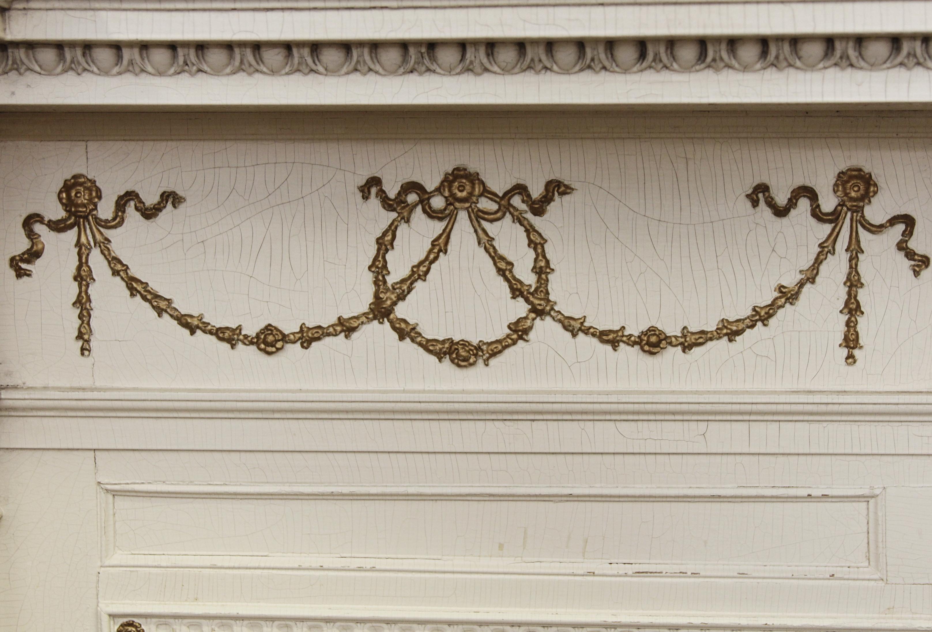 Federal style mantel with egg and dart details and slim columns on each side. This mantel is in great condition, with minor wear and tear and peeling paint. Made by E. Bradley Currier Co. on September 26, 1905. Style 758BC. This can be seen at our