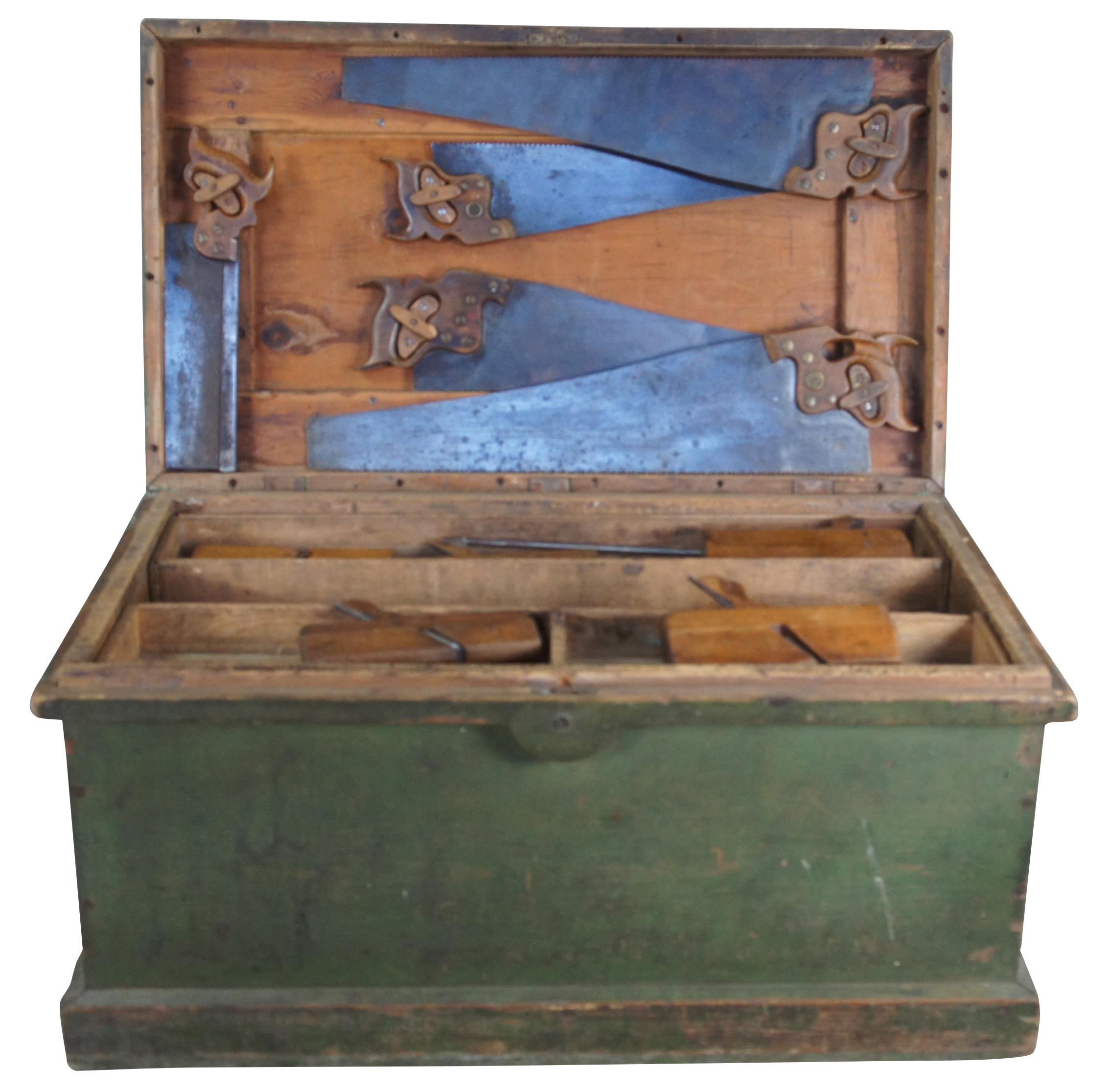 An exceptional and rare antique pine carpenters tool chest or trunk featuring five Disston hand saws, a bunch of planers and various extras. Marked along the upper lid, 