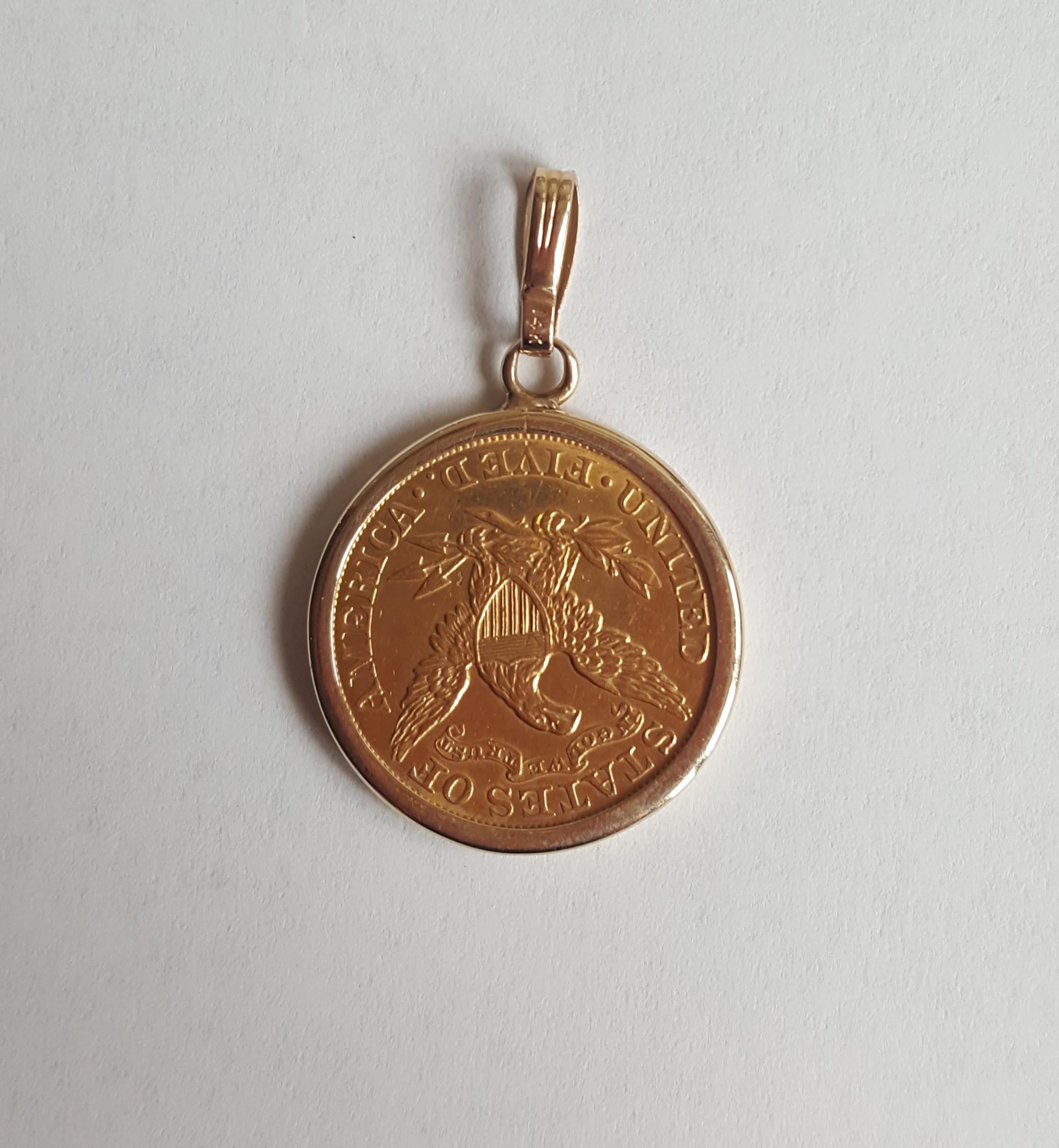Rare 1906 Liberty Half Eagle coin set in a 14kt yellow gold bezel bail pendant. The coin is made of 90% gold and 10% copper, and the total weight of both the bezel and coin is 9.4 grams. The coin's denomination and year are clearly stated in the