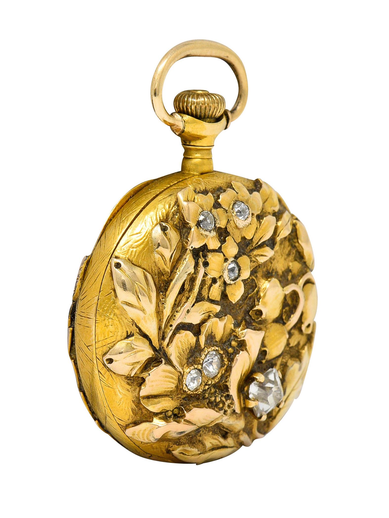 Circular pocket watch features a white face with gold numerals and antique watch hands

With a glass cover set in a 18 karat rose gold case with 18 karat yellow gold appliquè

Depicting highly rendered foliate and florals at back and front

Old mine