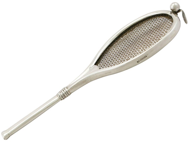 An exceptional, fine, impressive and unusual antique Edwardian English sterling silver tea strainer modelled in the form of a tennis racket; an addition to our silver teaware collection.

This exceptional antique Edwardian sterling silver tea