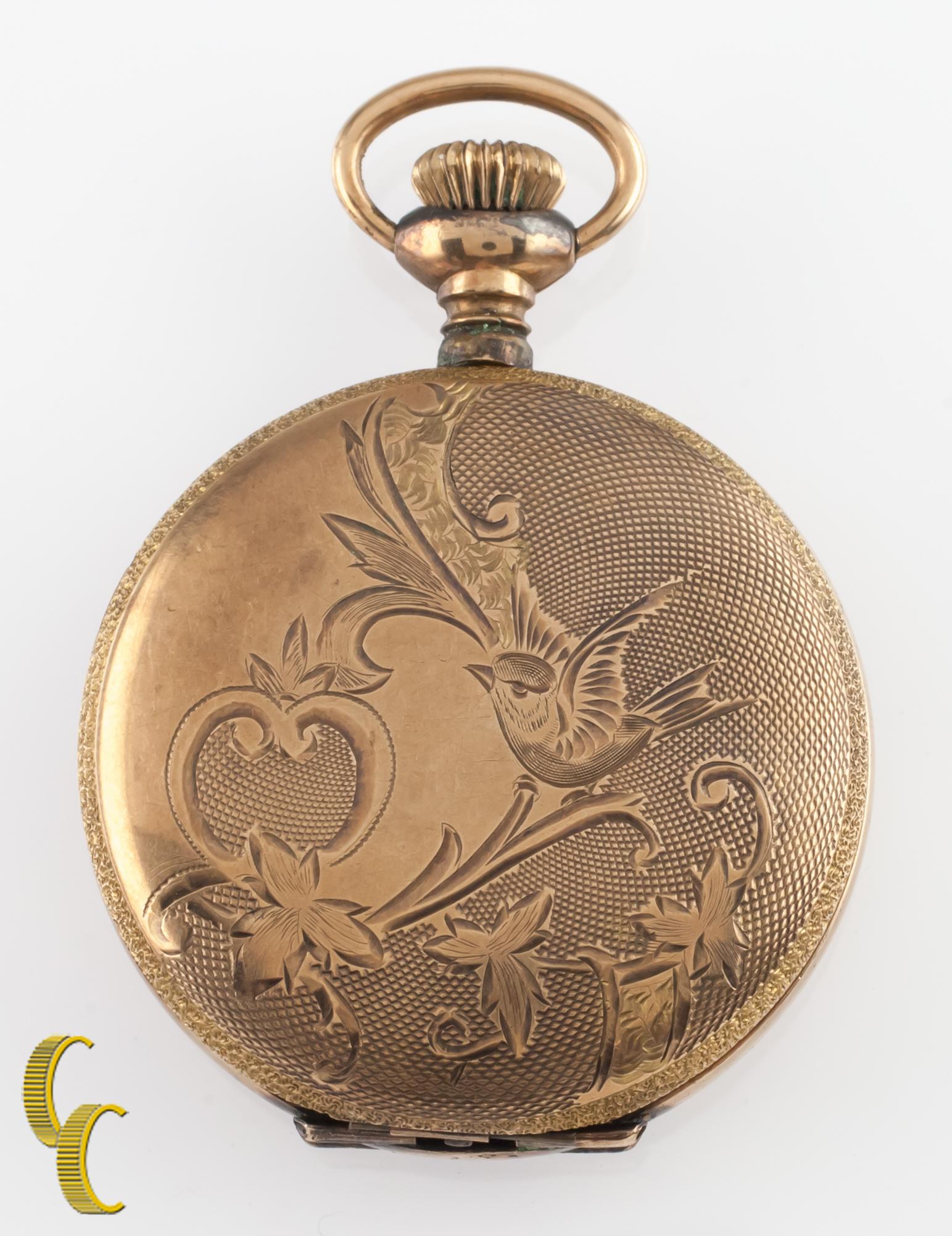 Beautiful antique Illinois pocket watch with white dial including black hands and a dedicated seconds dial.
Yellow gold-filled case with intricate hand-etched design on case.
Black numbers.
Case serial # 6169778.
15-jewel Illinois movement serial #