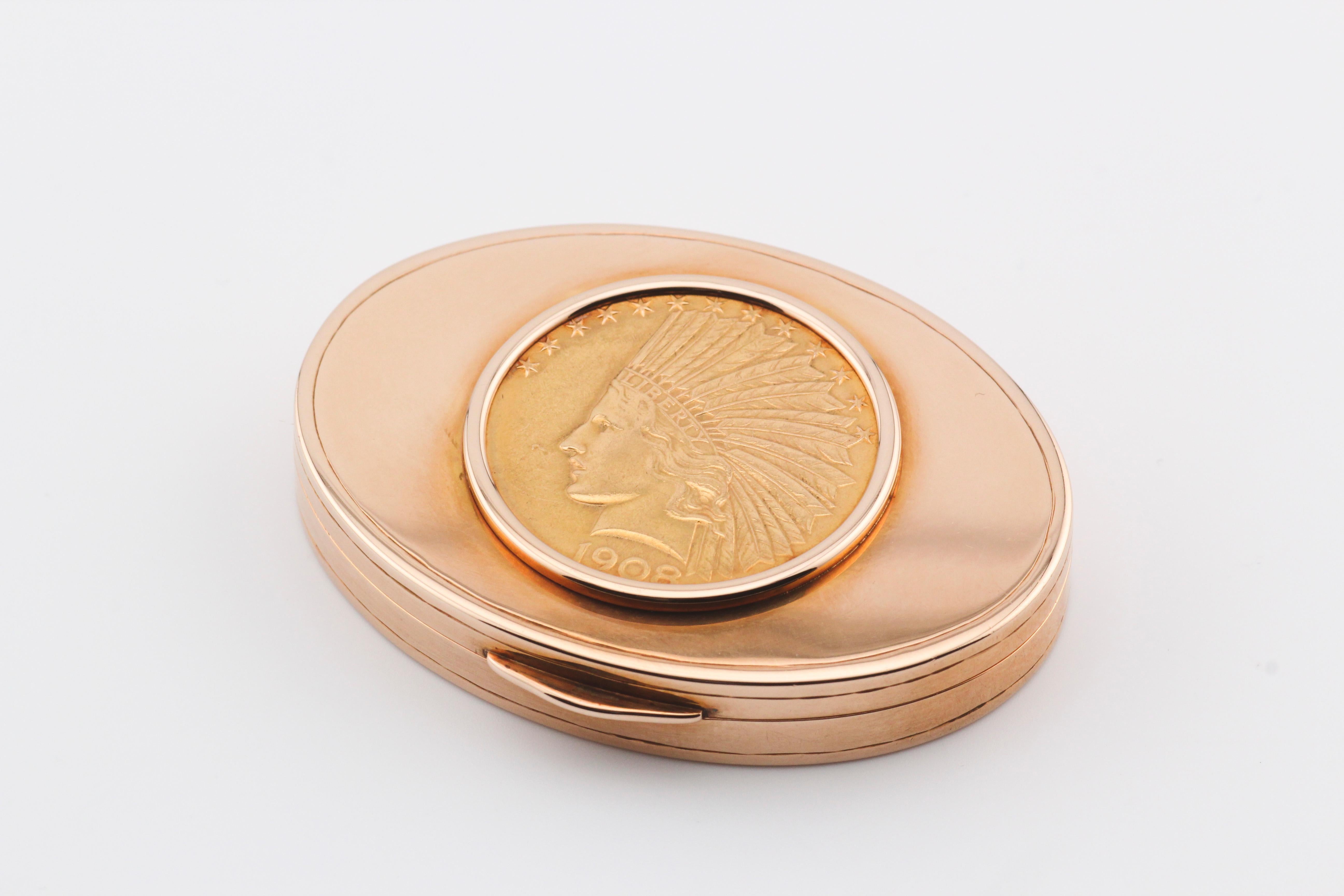 The 14K Yellow Gold Oval Pill Box with 1908 Ten Dollars USA Coin inlay is a striking and functional piece that beautifully marries luxury and history. Crafted with meticulous attention to detail, this pill box is a testament to fine craftsmanship
