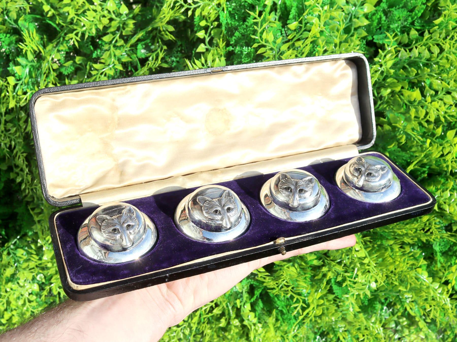 An exceptional, fine and impressive set of four antique Edwardian English sterling silver menu / card holders, boxed, an addition to our diverse dining silverware collection.

These exceptional and rare antique Edwardian cast sterling silver