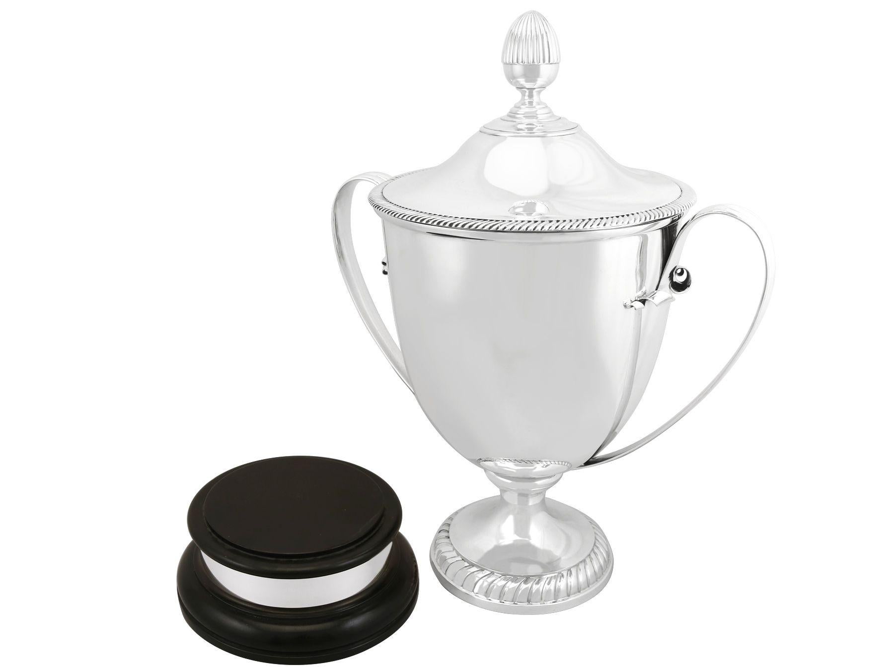 A magnificent, fine and impressive, large antique Edwardian English sterling silver presentation cup and cover; an addition to our presentation silverware collection.

This magnificent antique Edwardian sterling silver cup and cover has a plain