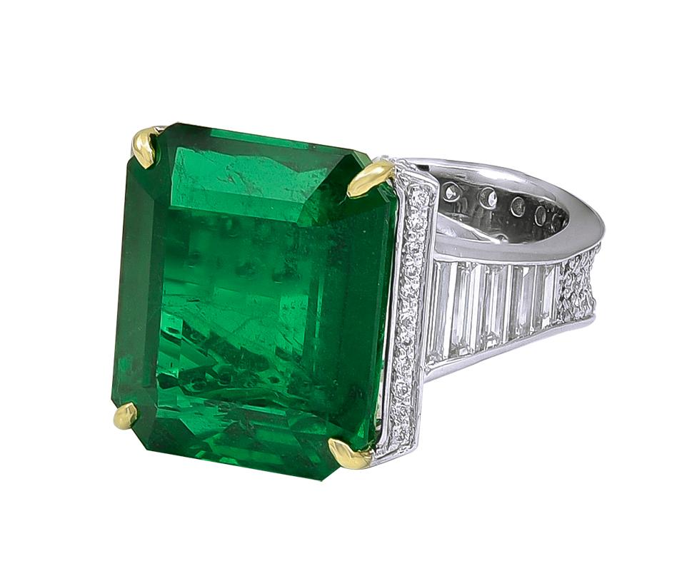 A majestic 19.09 Carat African Emerald and Diamond Ring. With white diamonds weighing 2.54 carats. This marvelous piece is set in Platinum material. The bottom shank measures 0.31