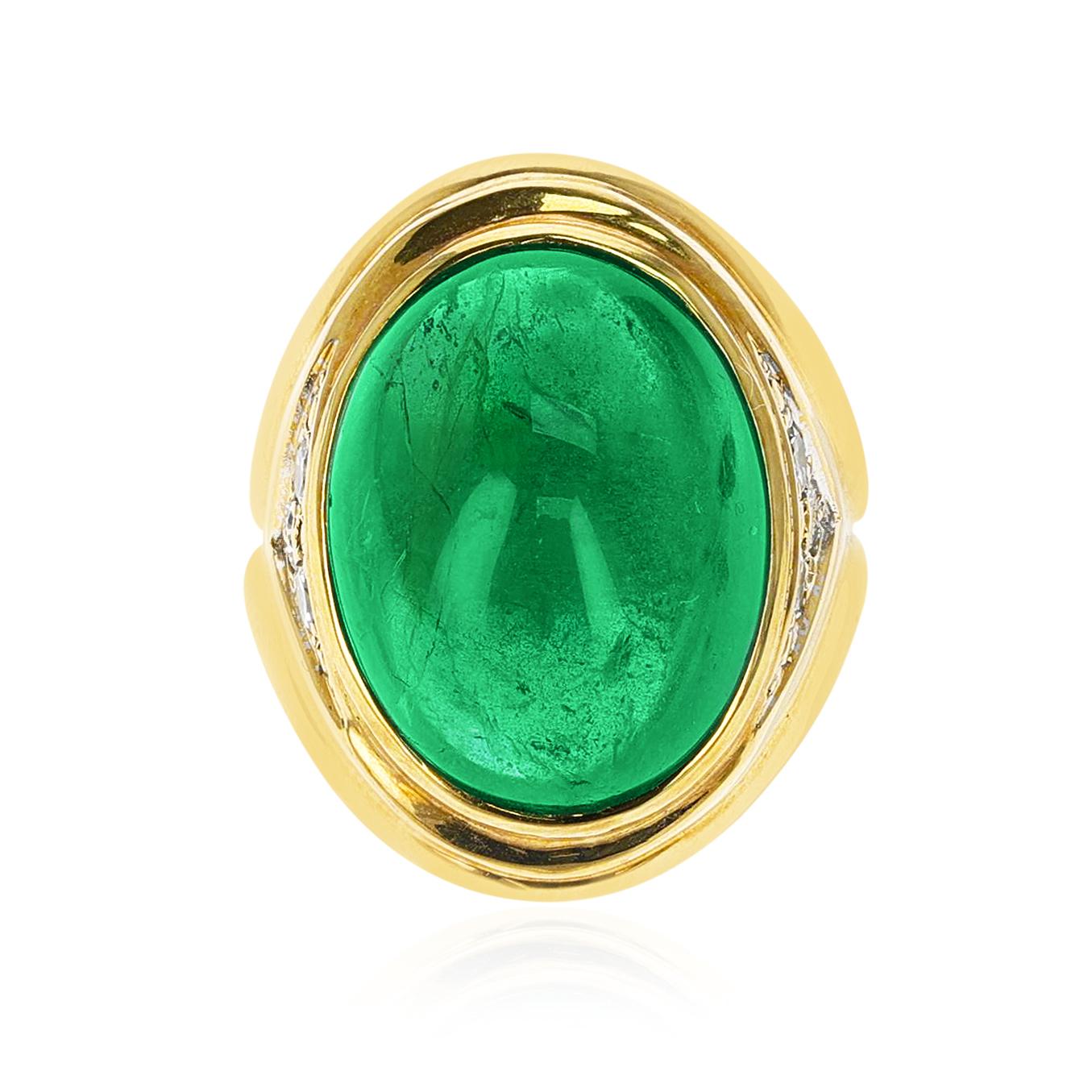 A 19.09 ct. Emerald Cabochon Ring with Diamonds made in 18 Karat Yellow Gold. The Diamonds weigh appx 0.40 carats. The total weight of the ring is 27.61 grams. The ring size is US 6. 