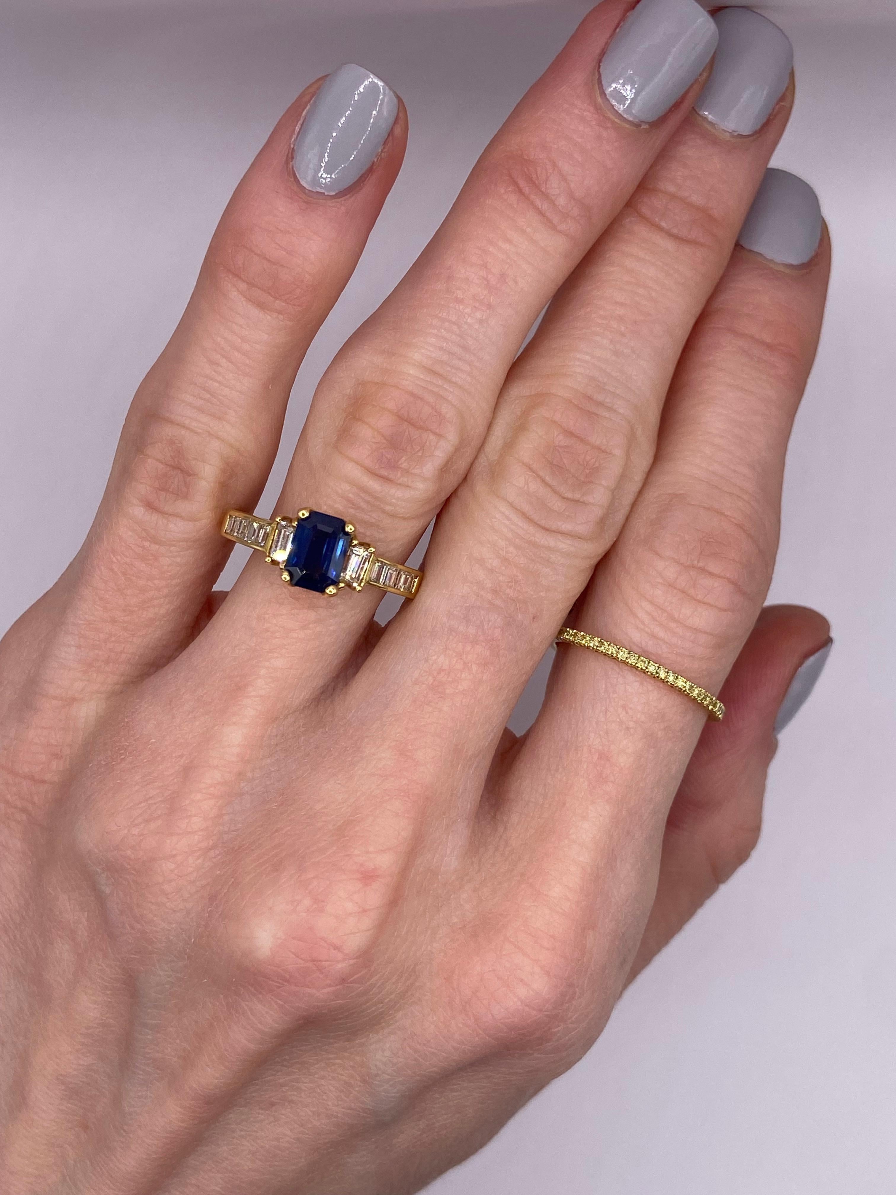 Metal: 18KT Yellow Gold
Finger Size: 6.75
(ring is size 6.75, but is sizable upon request)

Number of Emerald Cut Sapphires: 1
Carat Weight: 1.25ctw
Stone Size: 7 x 5mm

Number of Emerald Cut Diamonds: 2
Carat Weight: 0.40ctw

Number of Baguette