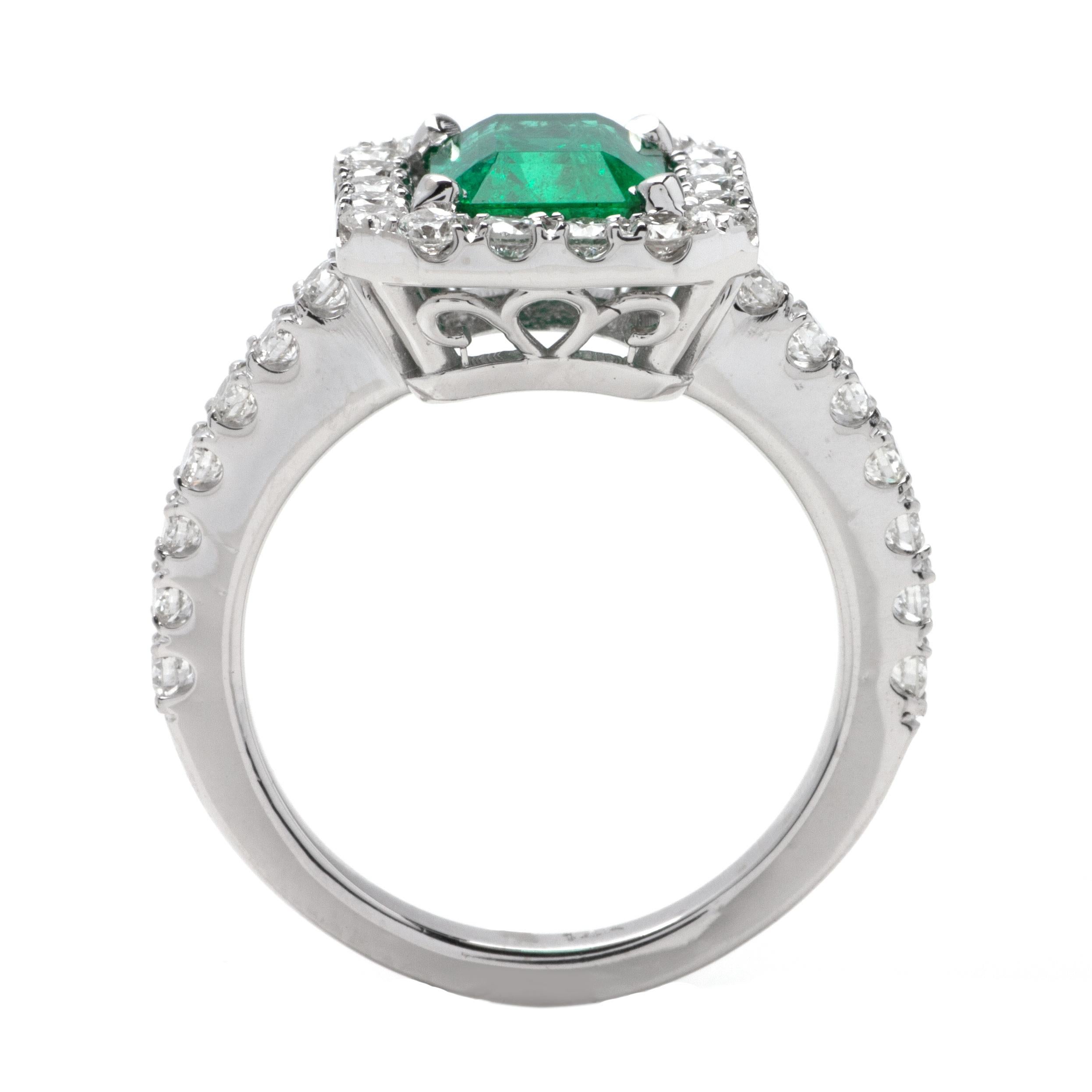 This ring features a halo design of G color, VS1 clarity, and 0.90ct Round side diamonds set in 14K white gold. The center gemstone is a 1.90ct green emerald. 