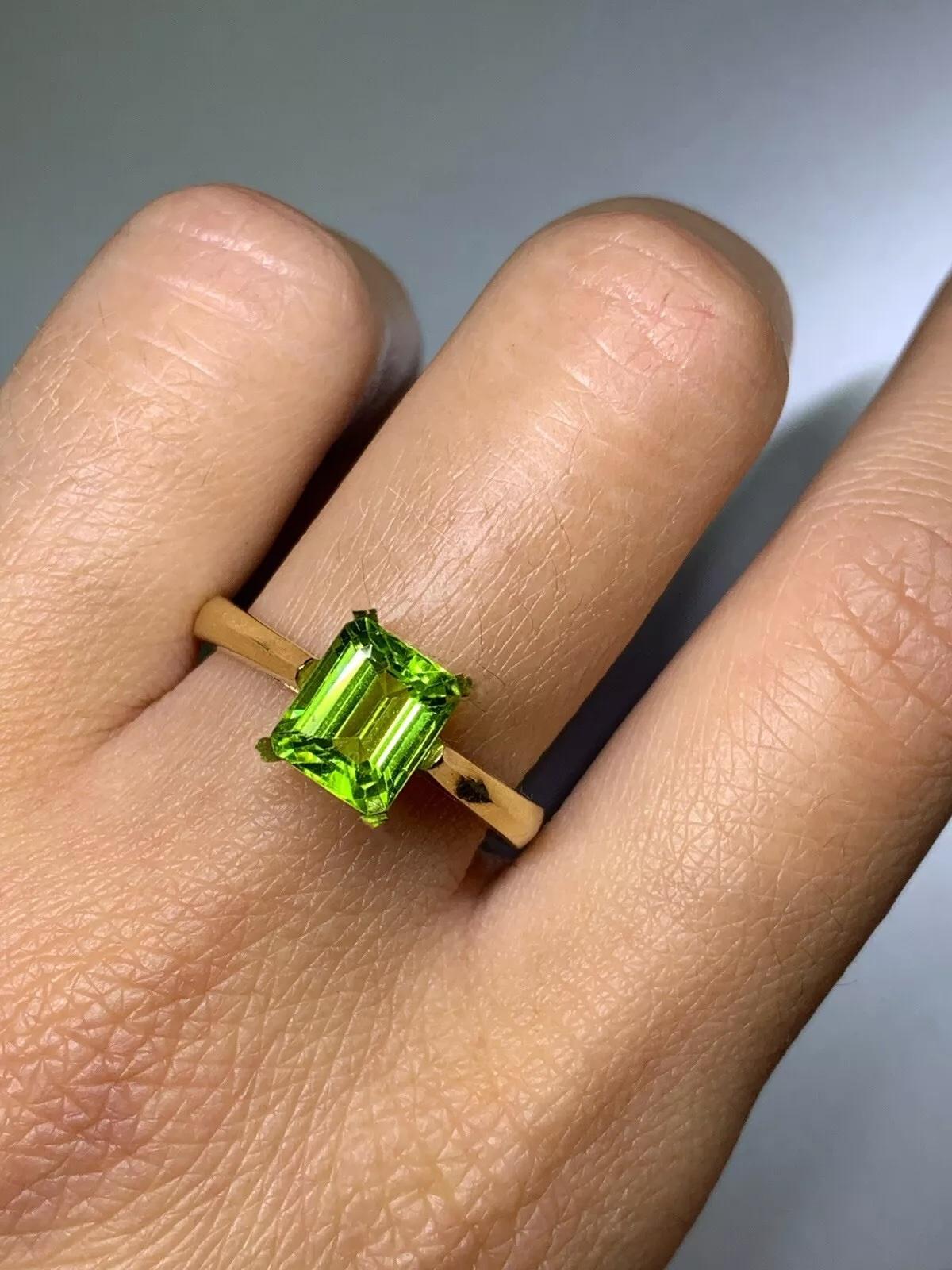 1.90ct Peridot green emerald solitaire engagement ring in 18ct yellow gold.

Gorgeous 1.90ct green peridot natural untreated emerald shape in 18k yellow gold band.

Hallmarked

The ring can be resized

Box and valuation included.