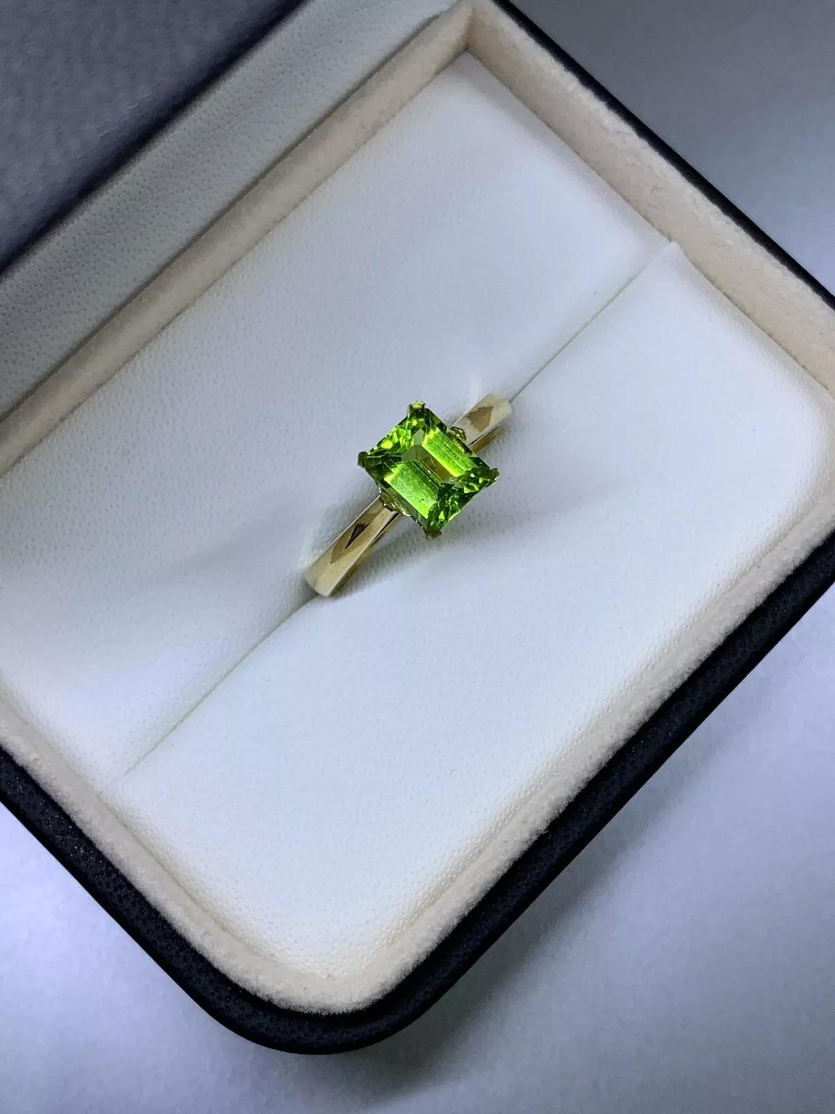 Emerald Cut 1.90ct Peridot green emerald solitaire engagement ring in 18ct yellow gold. For Sale