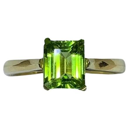 1.90ct Peridot green emerald solitaire engagement ring in 18ct yellow gold.