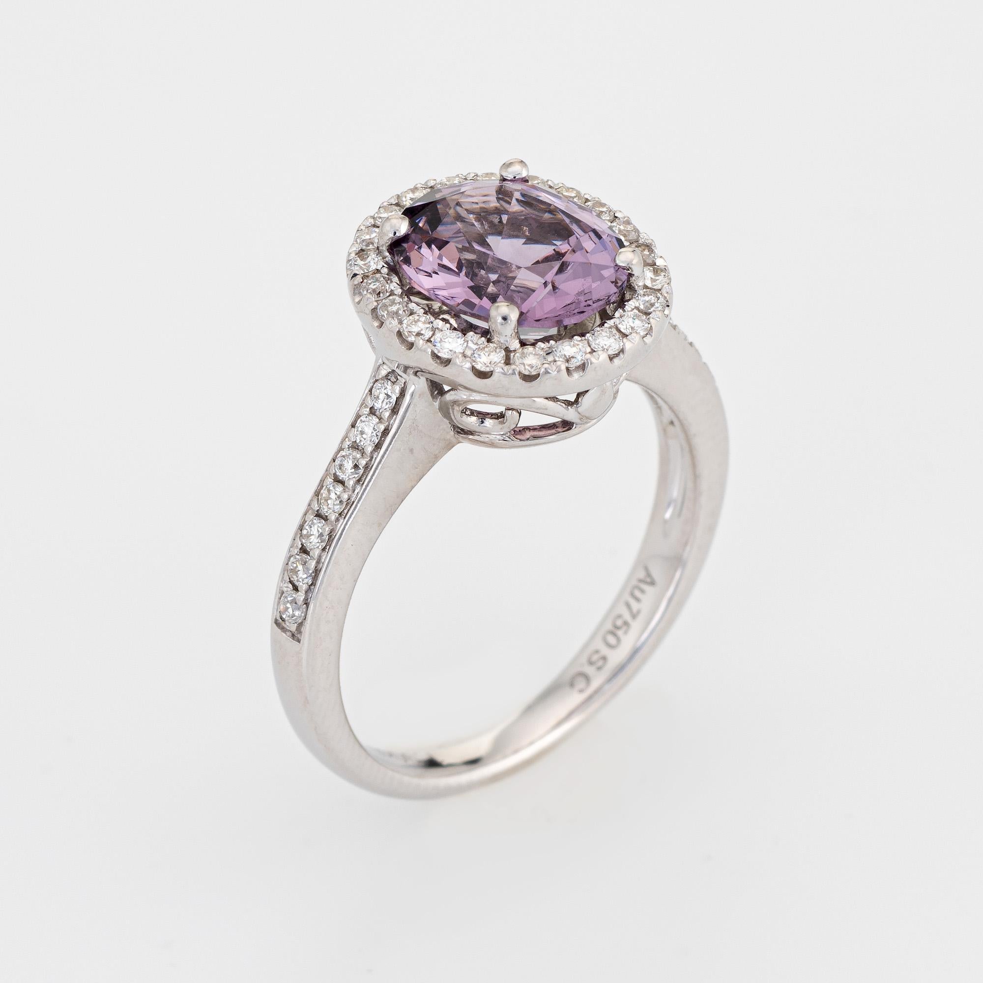 Stylish purple spinel & diamond ring (circa 2000s) crafted in 14 karat white gold. 

Oval faceted purple spinel measures 8.5mm x 7mm (1.90 carats), accented with an estimated 0.28 carats of diamonds (estimated at H-I color and VS2-SI1 clarity). The