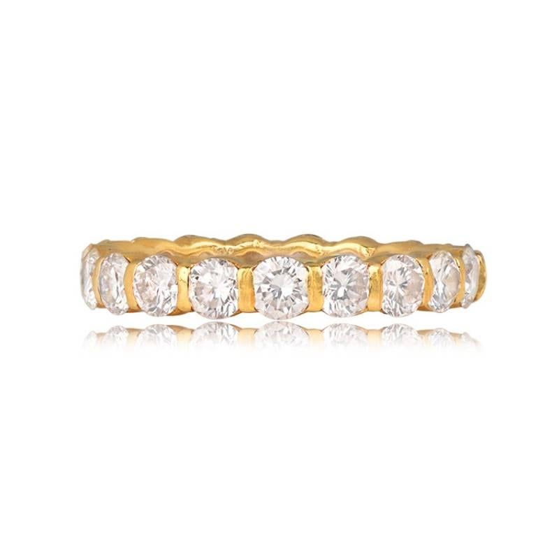 An exquisite Emory eternity band skillfully handcrafted in 18k yellow gold. Adorned with round brilliant diamonds in a shared-bar setting, the total diamond weight is approximately 1.90 carats. The band boasts a width of 2.85mm and is sized
