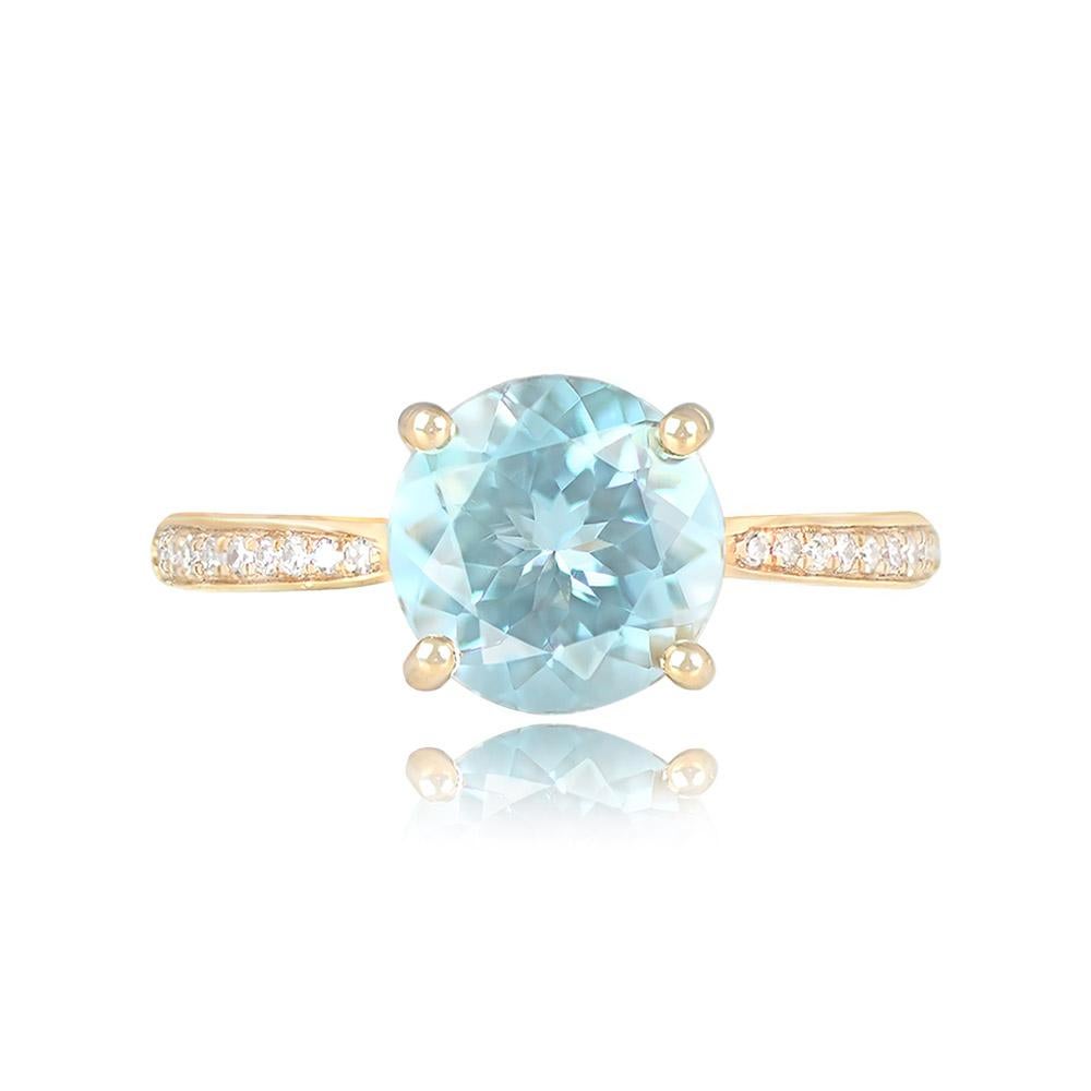 This exquisite engagement ring showcases a 1.90-carat round-cut aquamarine held securely by prongs, accentuated by single-cut diamonds along the shoulders. The collective diamond weight is approximately 0.12 carats, adding a touch of brilliance to