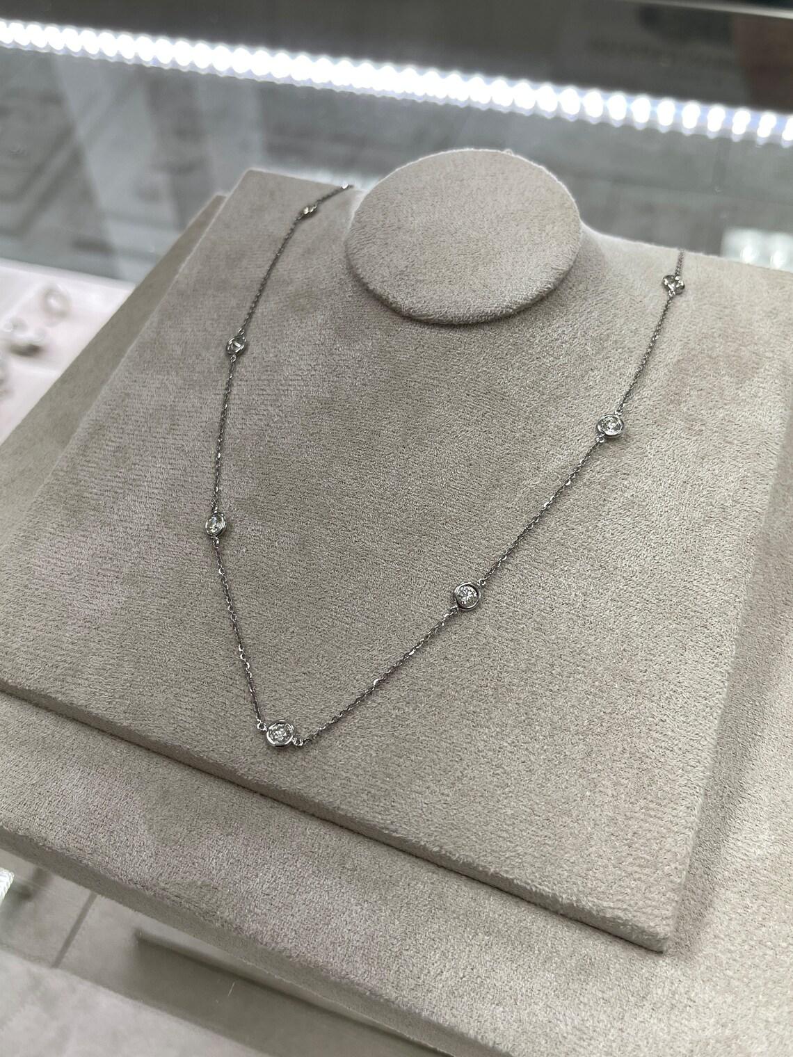 Simple and sophisticated is probably one of the only words to describe this chic diamond by the yard necklace. Ten brilliant round diamonds, two inches apart, can be seen throughout the entire piece. Almost two carats in diamonds, and set in 14K