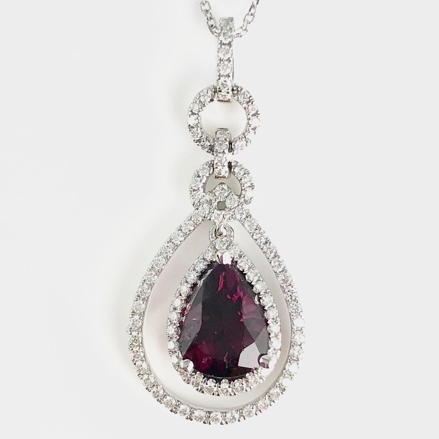 Indulge in the allure of our exquisite sweet pendant, a true masterpiece crafted just for you. Nestled at its heart is a mesmerizing 1.91 carat pear-shaped raspberry garnet, radiating with a rich, enchanting hue. 

This captivating gem is embraced