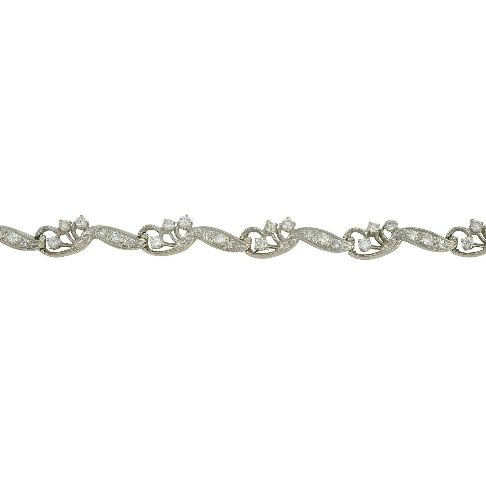 Estate 1.91 CTW diamond bracelet marked Kahn. This 14 karat white gold bracelet has 54 diamonds at 1.91 CTW with VS2-SI2 clarity and G-I color. This white gold diamond bracelet has makers mark of Kahn.Dimensions6-7/8″ length